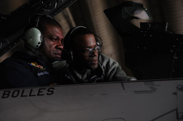 Staff Sgt. Trumaine Cox, 8th Aircraft Maintenance Squadron weapons load chief, shows Chief Master Sgt. Lee “Wolf Chief” Barr, 8th Fighter Wing command chief, how to perform a functional check on the centerline pylon of an F-16 Fighting Falcon at Kunsan Air Base, Republic of Korea, Jan. 23, 2015. Cox received the chance to show Wolf II and Wolf Chief how he contributes to the Wolf Pack mission. (U.S. Air Force photo by Senior Airman Divine Cox/Released) 