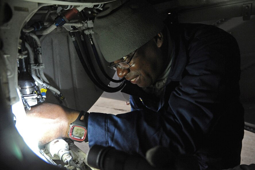 Chief Master Sgt. Lee “Wolf Chief” Barr, 8th Fighter Wing command chief, helps Staff Sgt. Trumaine Cox, 8th Aircraft Maintenance Squadron weapons load crew chief, install a centerline pylon fuel line at Kunsan Air Base, Republic of Korea, Jan. 23, 2015. Cox received the chance to show Wolf II and Wolf Chief how he contributes to the Wolf Pack mission. (U.S. Air Force photo by Senior Airman Divine Cox/Released)
