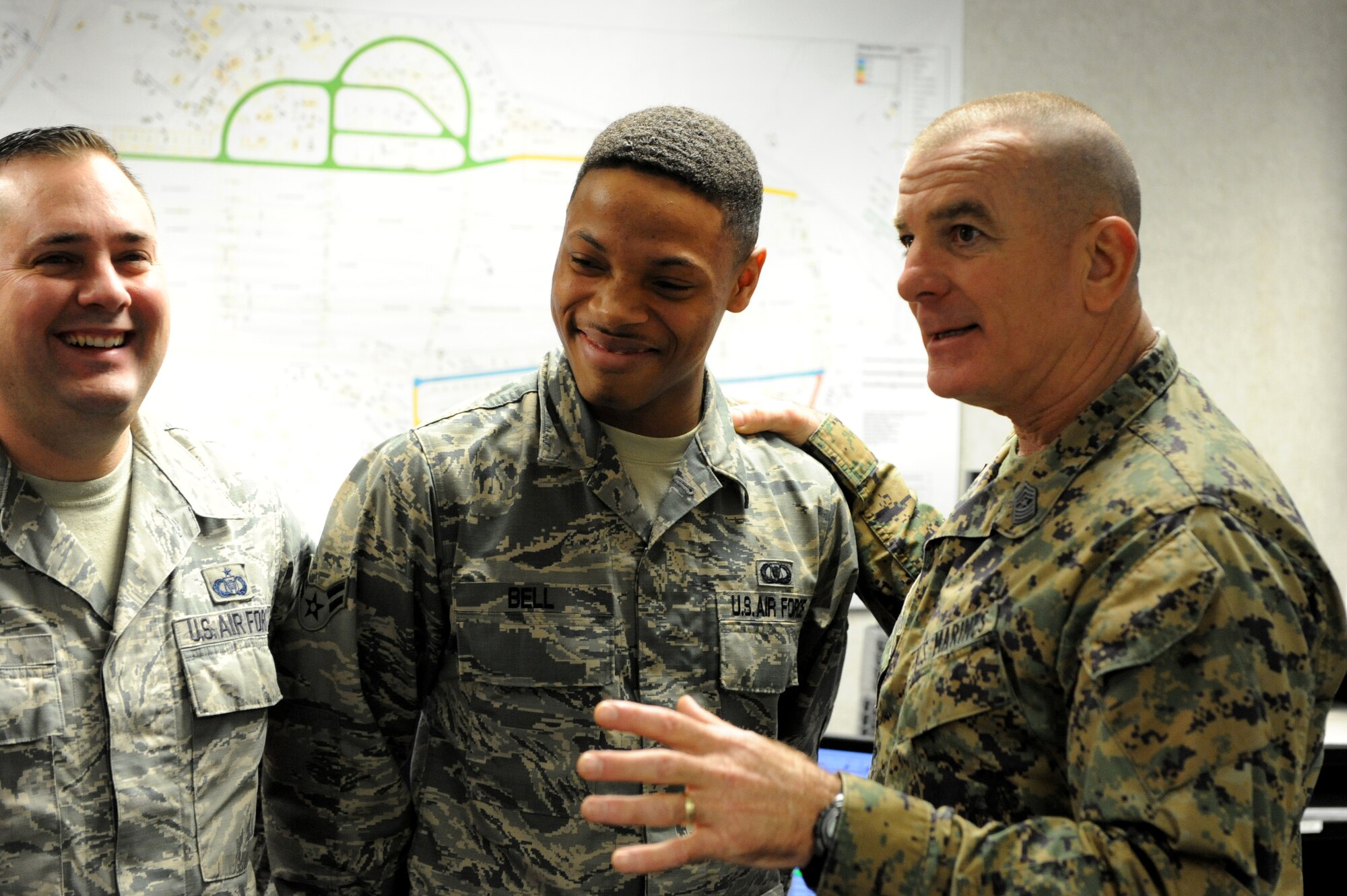 U.S. Marine Sgt. Maj. Bryan Battaglia, senior enlisted advisor to the chairman of the Joint Chiefs of Staff, asks questions and jokes around with Airman 1st Class Paris Bell, 18th Operations Support Squadron airfield management shift lead, on Kadena Air Base, Japan, Feb. 8, 2015.  Visiting allowed Battaglia to learn a little more about what Team Kadena does for the Department of Defense, but also about the many roles Kadena plays in global deterrence. (U.S. Air Force photo by Airman 1st Class Stephen G. Eigel)