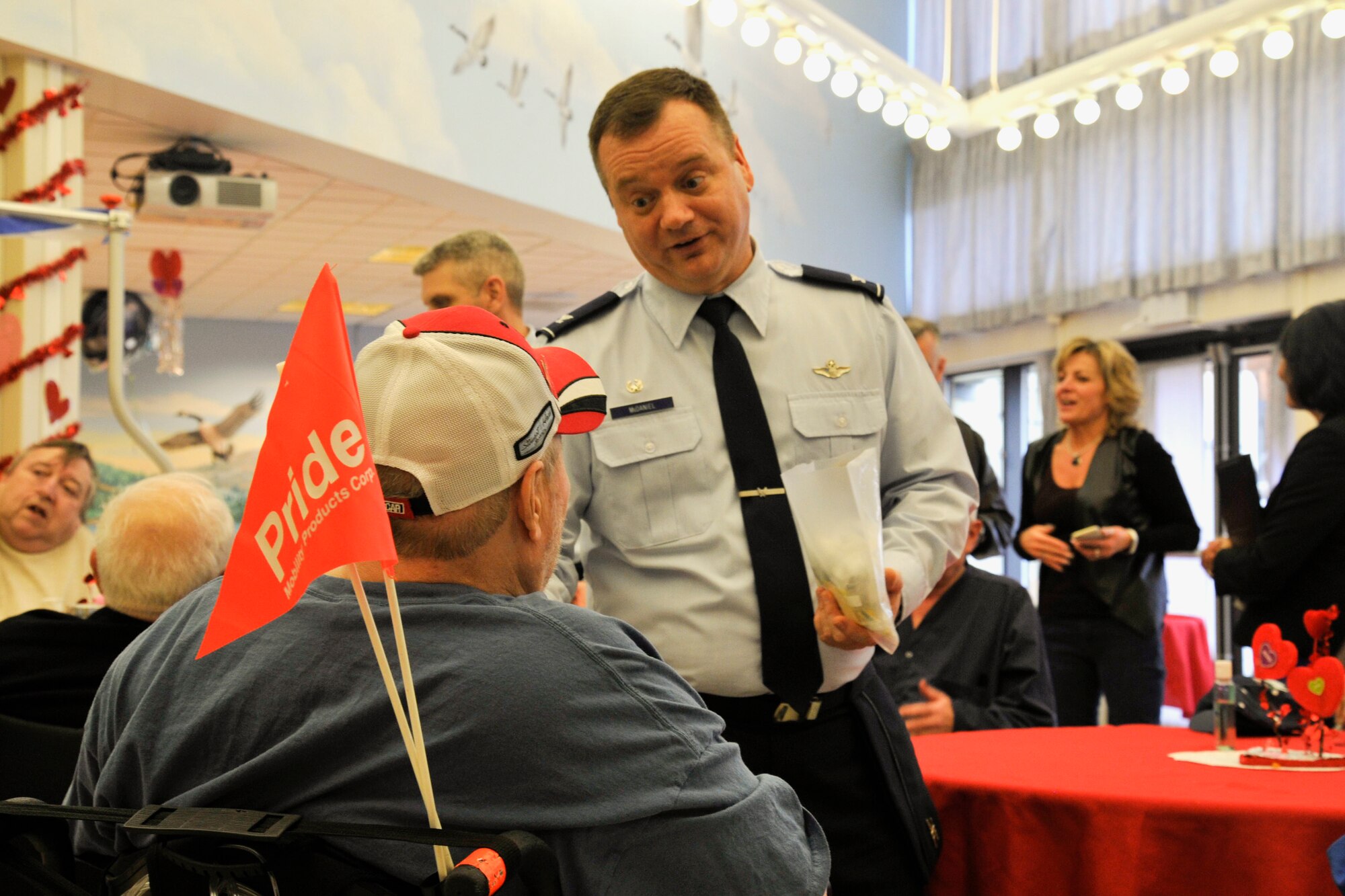 Col. Brian McDaniel, 92nd Air Refueling Wing commander, speaks with a veteran during the National Salute to Veteran Patients at the Spokane Veteran Medical Center Feb. 11, 2015, in Spokane, Wash. McDaniel, along with other Team Fairchild leaders, presented veterans with pins, hats and expressed his appreciation to the veterans for their service. (U.S. Air Force photo/Airman 1st Class Nicolo J. Daniello)