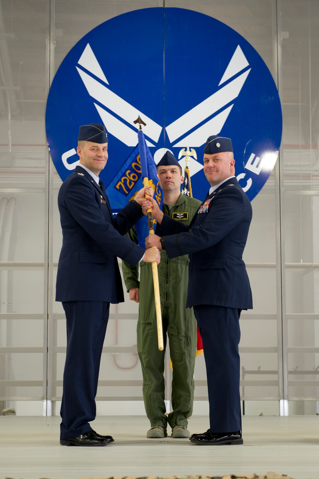 Lieutenant Colonel Richard Wageman, incoming 429th Reserve Air Combat Training Squadron commander, accepts the squadron’s guidon from Col. Brent Caldwell, 726th Operations Group commander, during a change of command ceremony Feb. 12, 2015 at Holloman Air Force Base, N.M. During the change of command, Wageman assumed control of the 429 RACTS from Lt. Col. Ryan Ogan. The 429 RACTS supports three regular Air Force formal training squadrons at Holloman with MQ-1 Predator and MQ-9 instructor pilots, sensor operators and mission intelligence coordinators. (U.S. Air Force photo by Staff Sgt. Stacy Moless/Released)