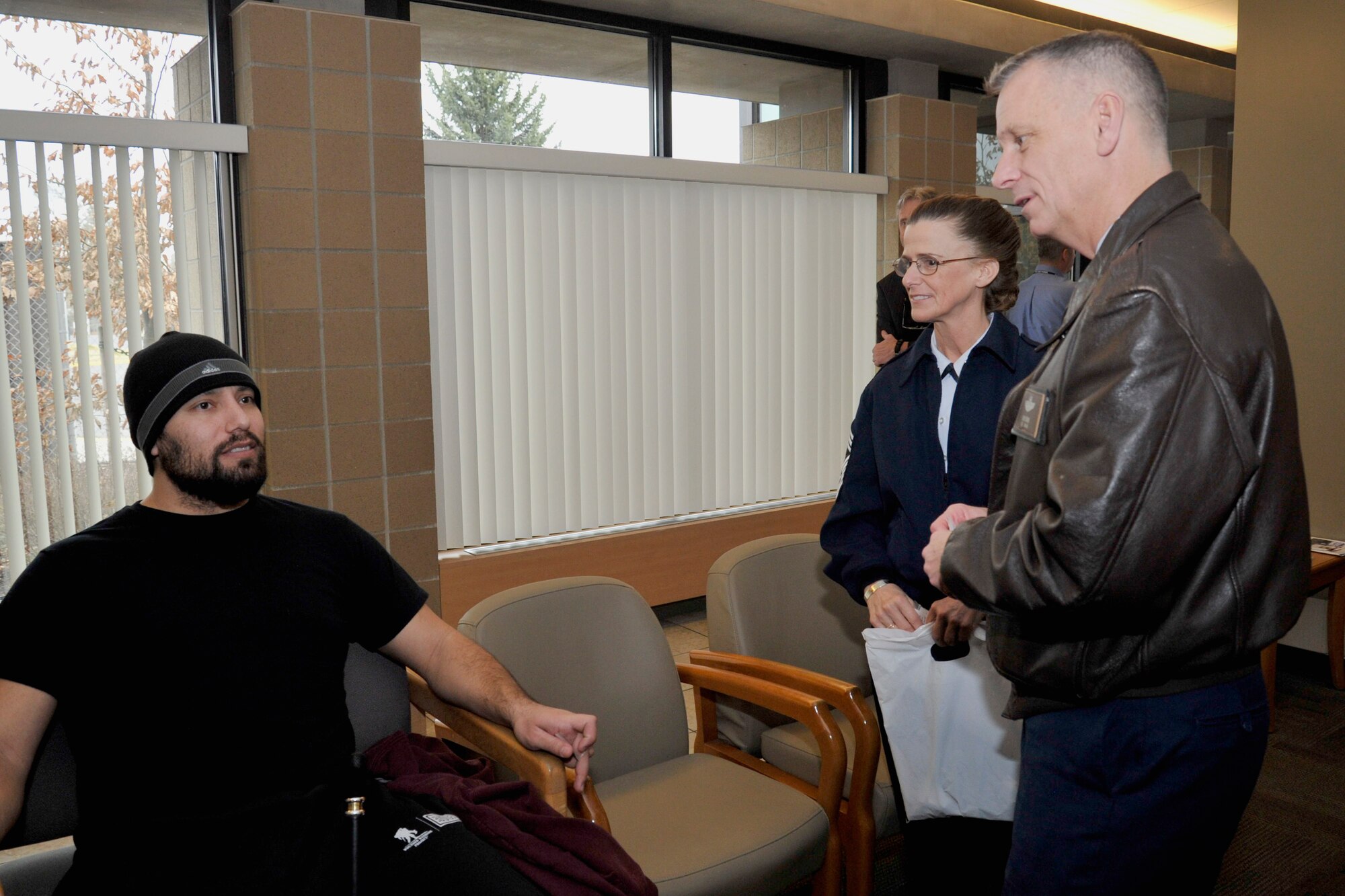 Col. Daniel J. Swain, 141st Air Refueling Wing commander, and Chief Master Sgt.  Mary Crofoot, 141st Operations Group chief, hand out Air National Guard pins to veterans at the Spokane Veteran Medical Center Feb. 11, 2015, in Spokane, Wash. The 141st ARW leaders visited the VAMC to pay tribute and express their appreciation to veterans during the National Salute to Veteran Patients. (U.S. Air Force photo/Airman 1st Class Nicolo J. Daniello)