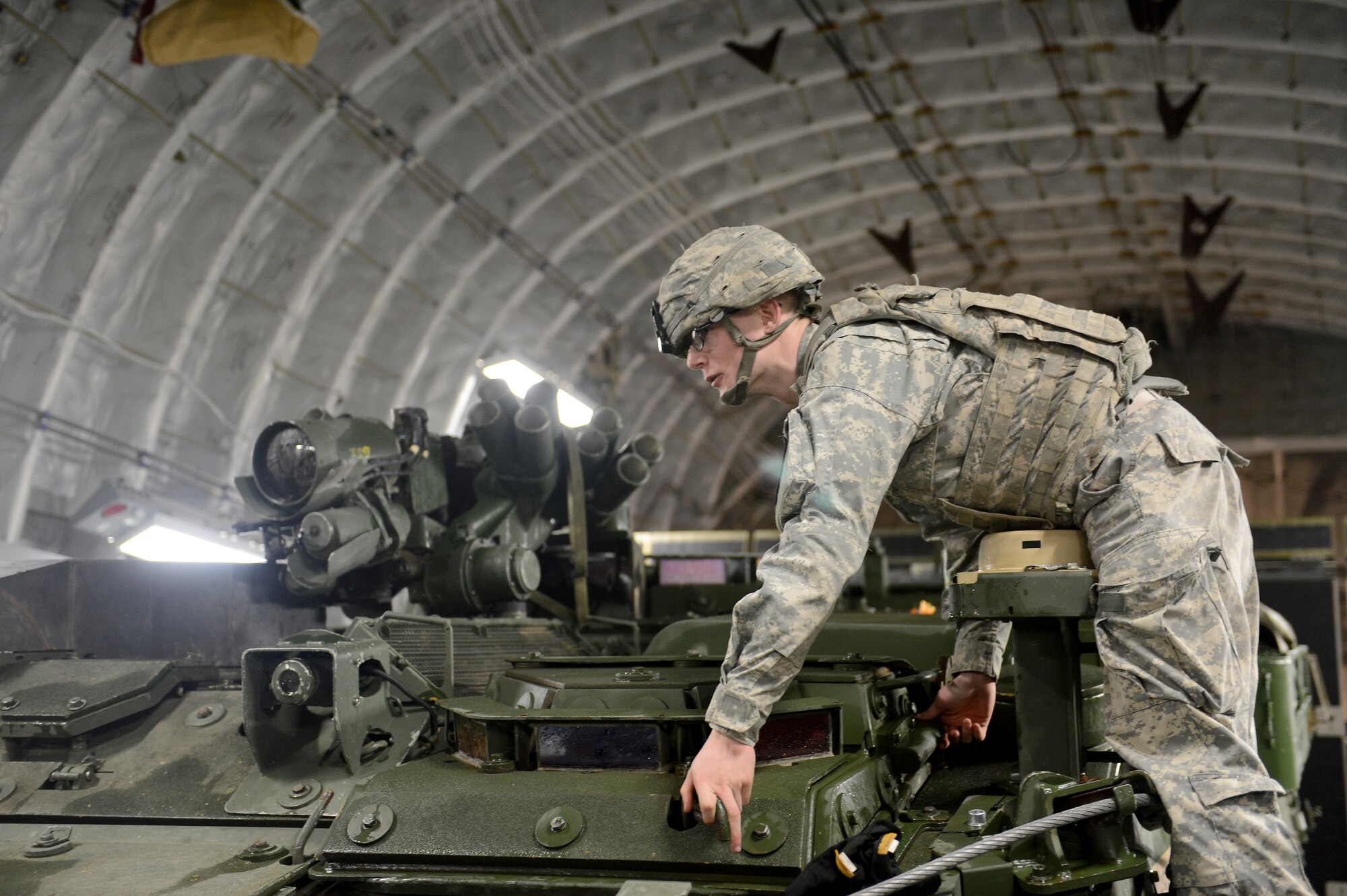 Pfc. Robert Yeaney, 23rd Infantry Stryker driver, closes a latch on a M1126 Stryker combat vehicle Feb. 4, 2015, during Exercise SNAPSHOT at Joint Base Lewis-McChord, Wash. During the exercise, Soldiers from Fort Lewis prepared Strykers for mobilization and coordinated with Airmen to illustrate their readiness for a short-notice deployment. (U.S. Air Force photo/Airman 1st Class Keoni Chavarria)