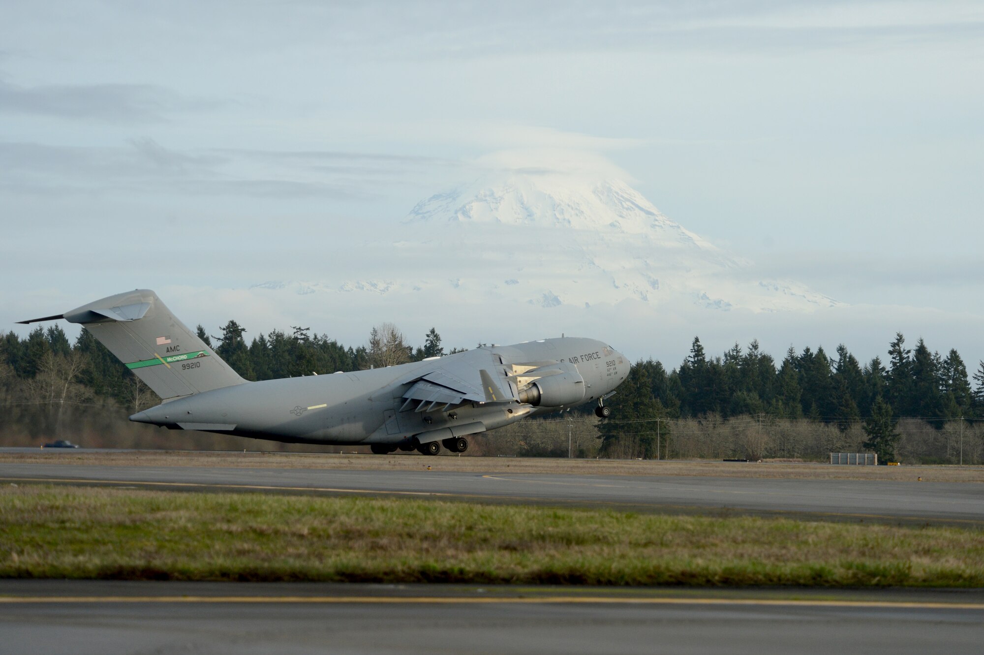 A Team McChord C-17 Globemaster III takes off from Joint Base Lewis-McChord, Wash. Feb. 3, 2015, during Exercise SNAPSHOT. The purpose of the exercise was to test deployment readiness and ability to execute direct delivery combat operation of McChord Airmen. (U.S. Air Force photo/Airman 1st Class Keoni Chavarria)