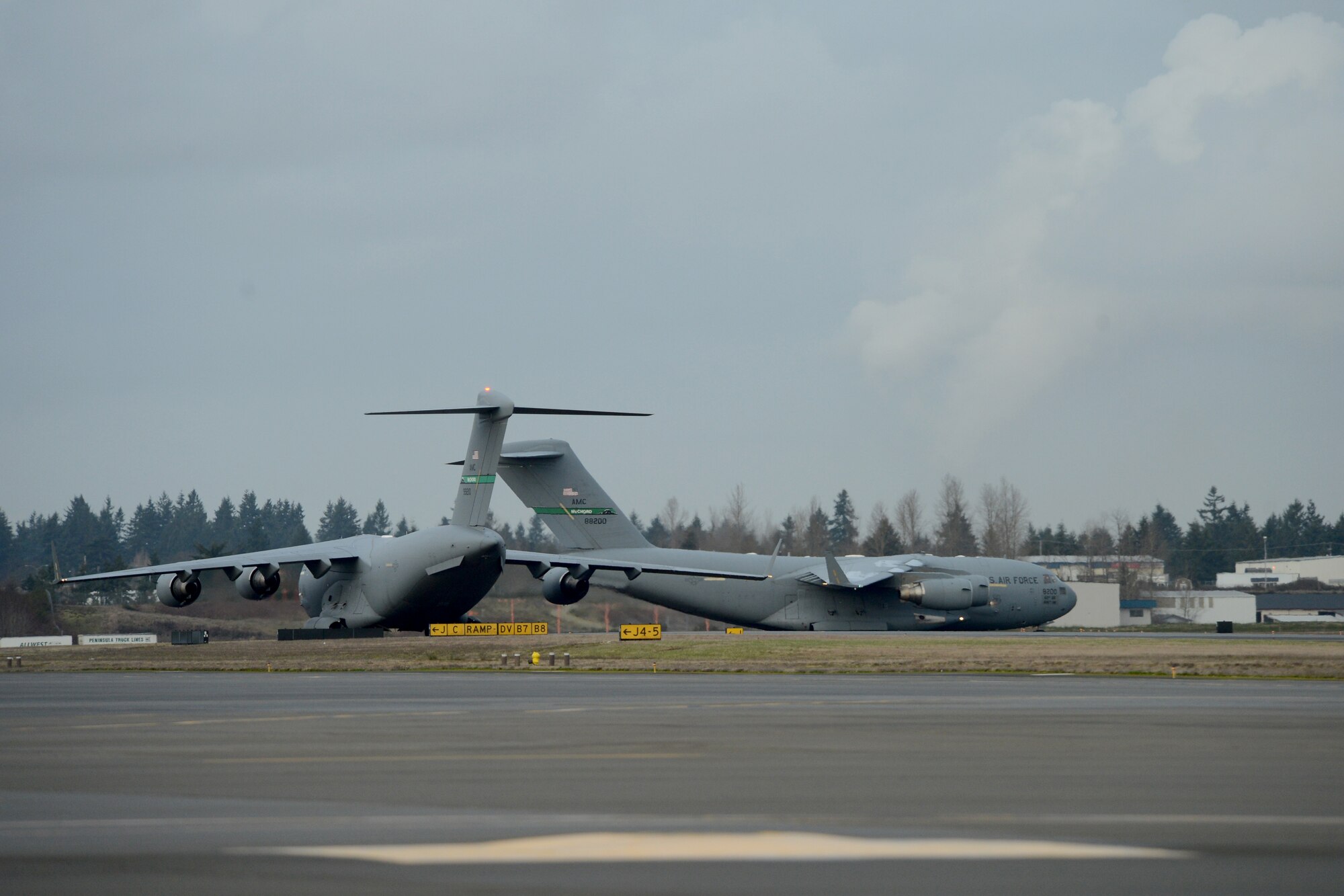 Two Team McChord C-17 Globemaster III’s taxi out onto a runway Feb. 3, 2015, during Exercise SNAPSHOT at Joint Base Lewis-McChord, Wash. The purpose of the exercise was to test deployment readiness and ability to execute direct delivery combat operation of McChord Airmen. (U.S. Air Force photo/Airman 1st Class Keoni Chavarria)