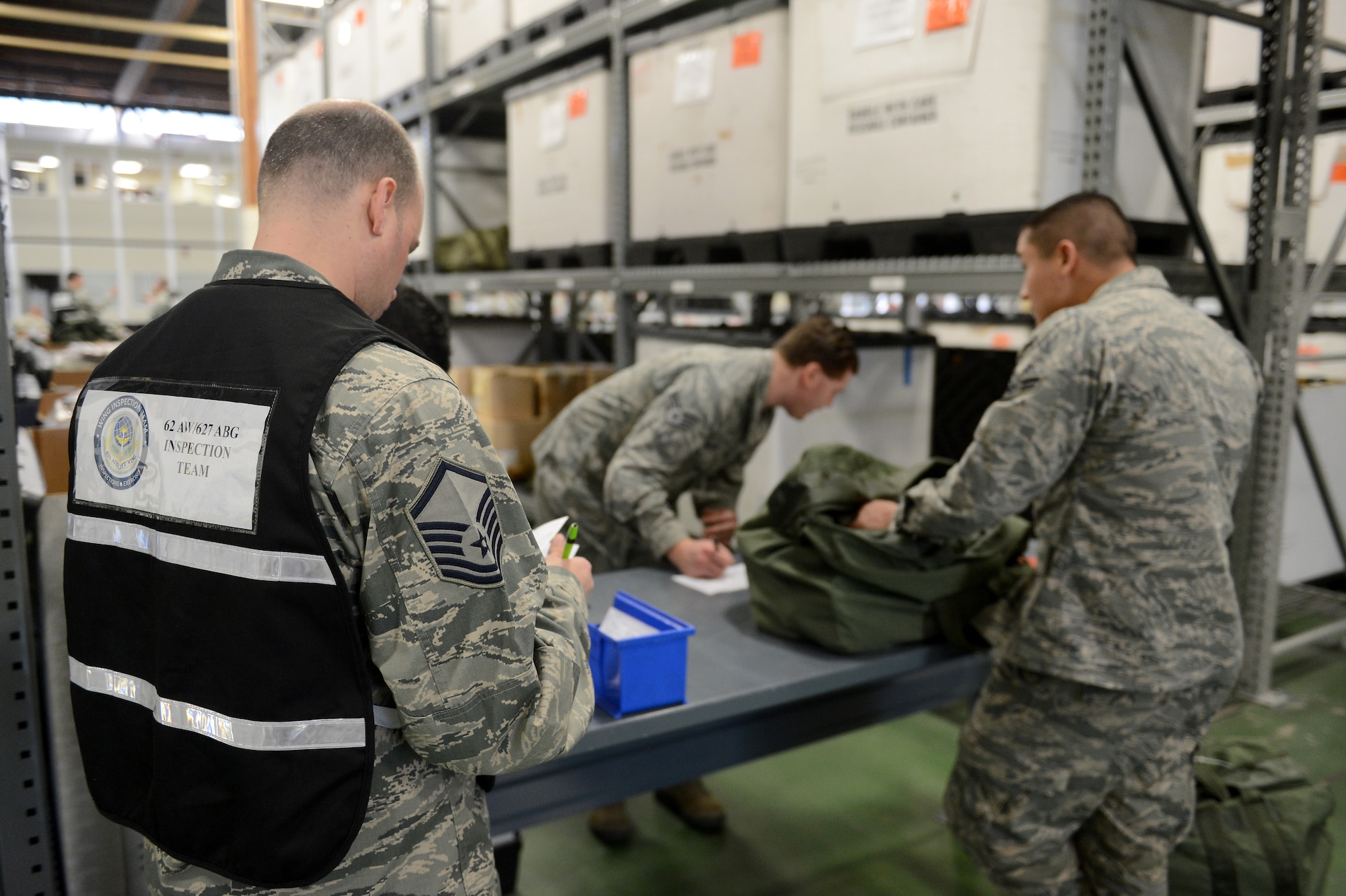 Master Sgt. Jay Speck, 627th Logistics Readiness Squadron NCO in charge of customer service, evaluates deployment processing line procedures Feb. 3, 2015, during Exercise SNAPSHOT at Joint Base Lewis-McChord, Wash. Members of the 62nd Airlift Wing, 446th AW and 627th Air Base Group were required to execute direct delivery combat operations. (U.S. Air Force photo/Airman 1st Class Keoni Chavarria)