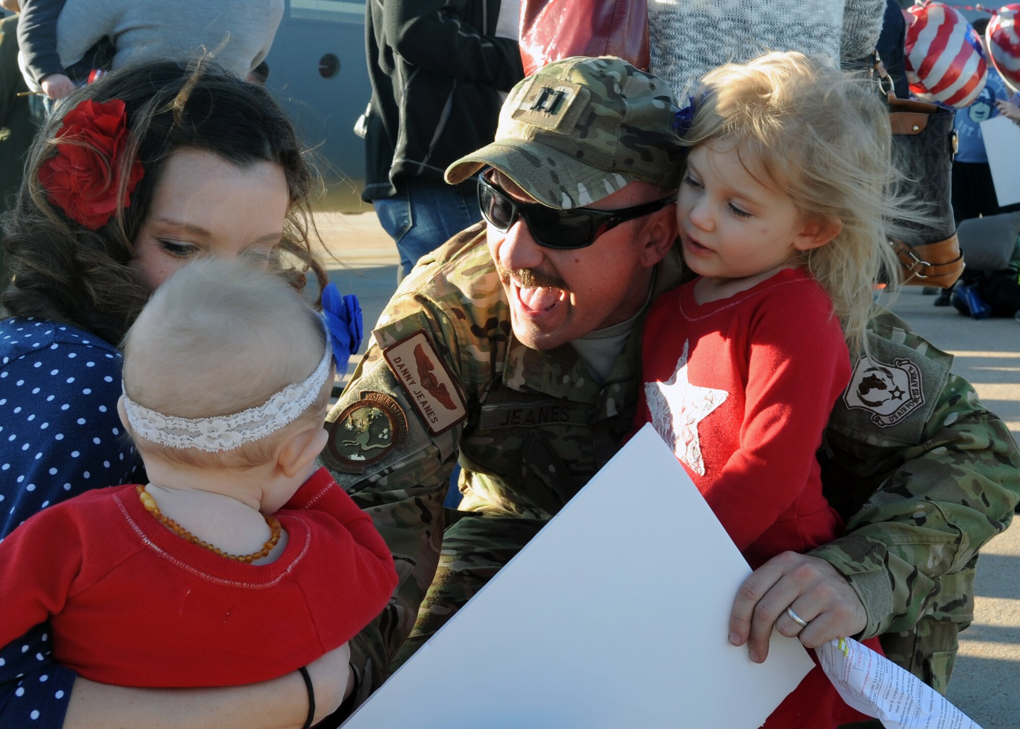 U.S. Air Force Capt. Daniel Jeanes, 317th Airlift Group executive, is greeted by his family Jan. 16, 2014, at Dyess Air Force Base, Texas. Jeanes was part of a group of more than 20 Airmen deployed to Djibouti, Africa, for five months. (U.S. Air Force photo by Airman 1st Class Autumn Velez/Released)