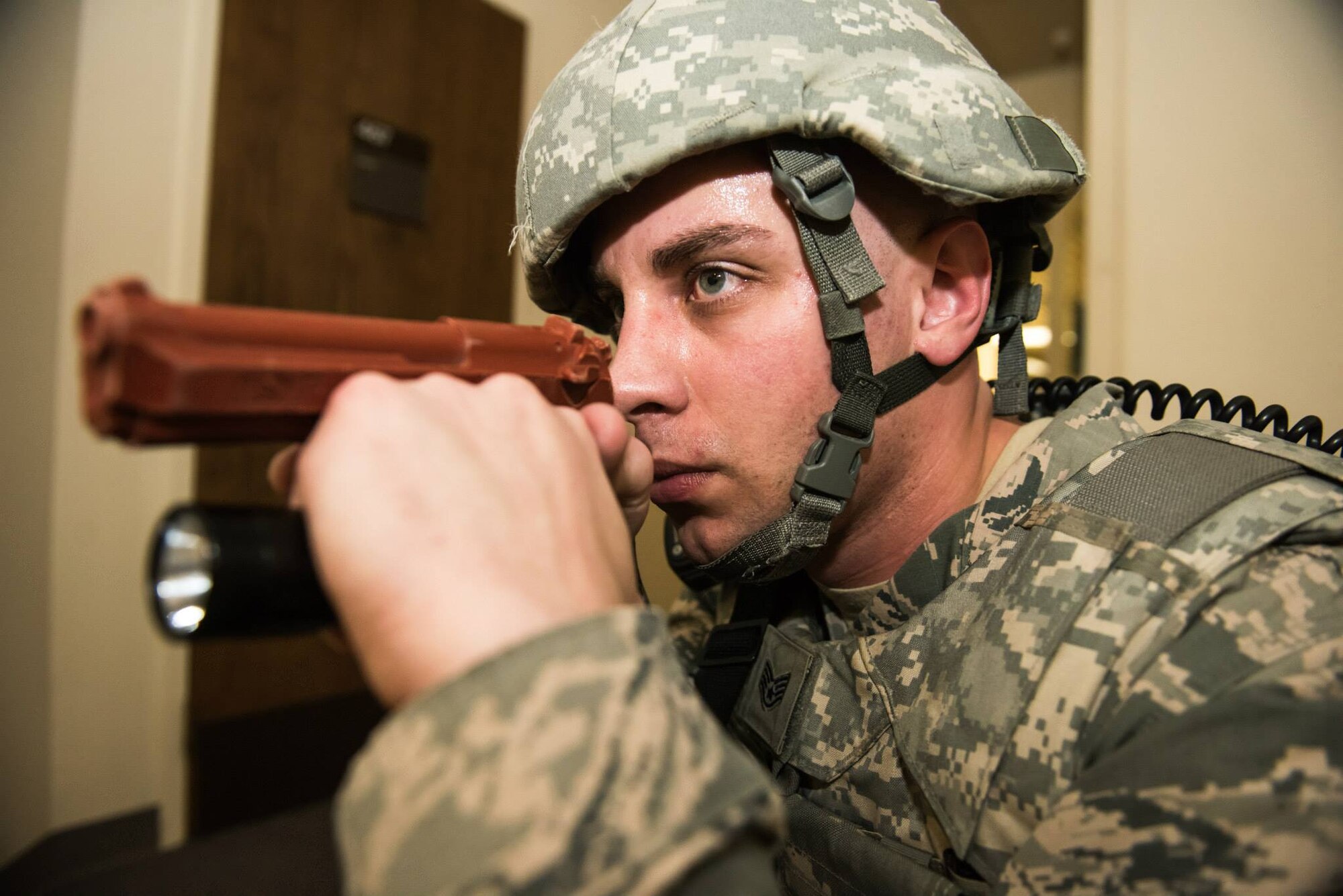 Staff Sgt. Tony Wagner, 366th Security Forces Squadron emergency control center controller, simulates an active shooter response at Mountain Home Air Force Base, Idaho, Jan. 28, 2015. The base participated in a week long exercise to test readiness to situations ranging from an active shooter all the way to immediate deployments. (U.S. Air Force photo by Airman Connor J. Marth/RELEASED)