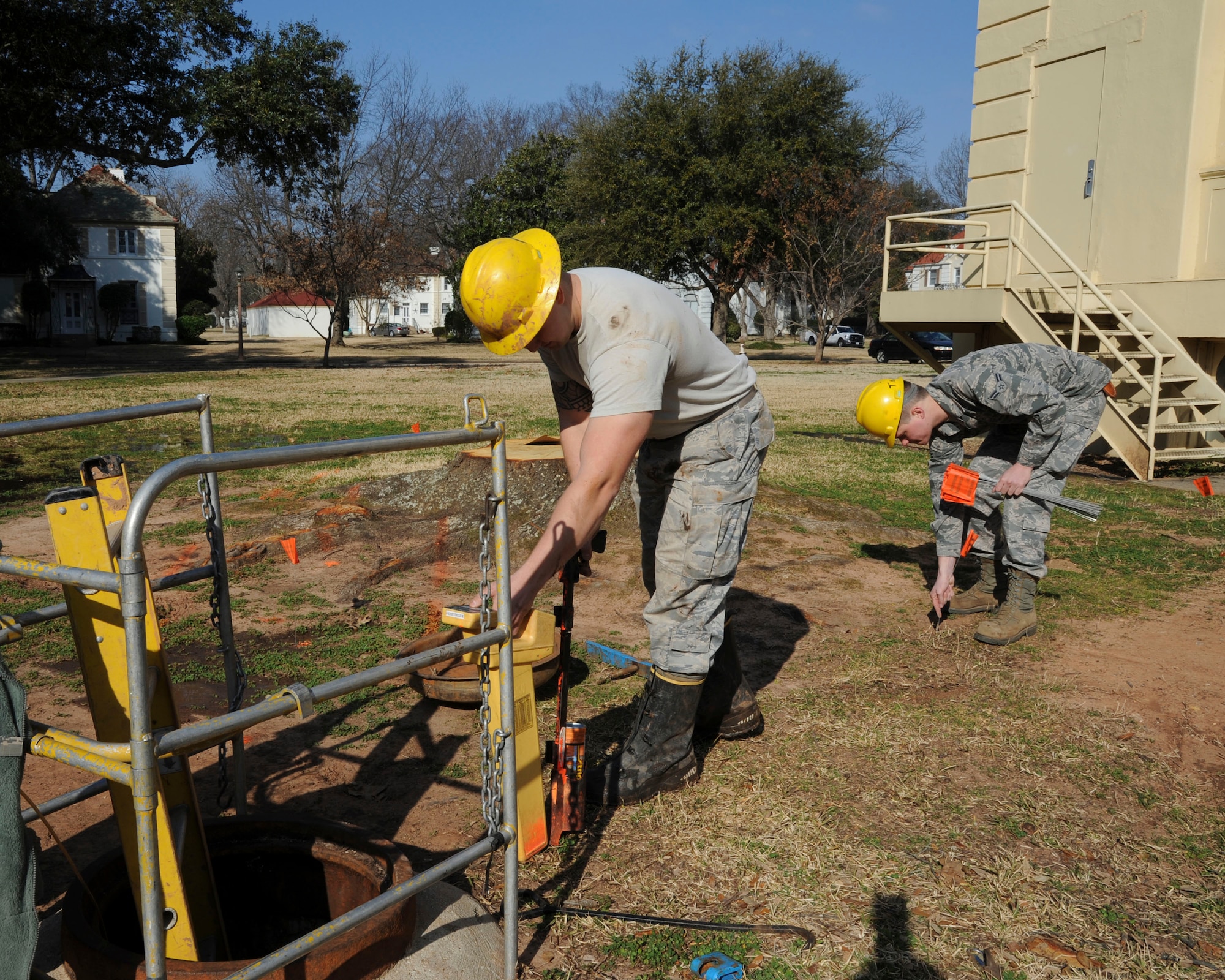 Senior Airman Creston Jenkins, left, and Airman 1st Class Tyler Tanner, 2nd Communications Squadron cable and antenna systems, locate and mark buried cables on Barksdale Air Force Base, La., Feb. 11, 2015. Cable Dawgs Airmen are responsible for buried and aerial cable and antenna networks in support of everyday communications. (U.S. Air Force photo/ Senior Airman Jannelle Dickey)