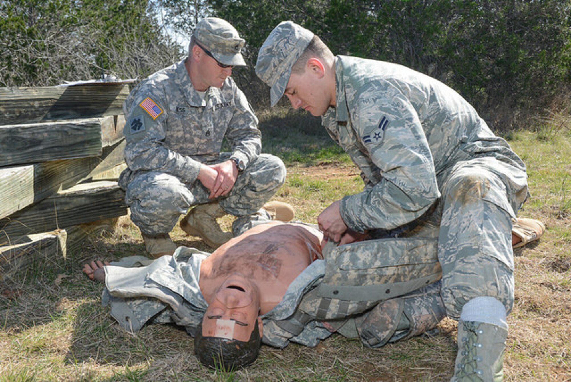 U.S. Air Force Airman 1st Class John Williams, 136th Maintenance Squadron, Texas Air National Guard, performs combat first aid on a combat-trauma mannequin during the 2015 Best Warrior Competition at Camp Swift, Texas, Feb. 7, 2015. The competition determines the best of the best warrior amongst Army and Air National Guardsmen. (photo by Master Sgt. Charles Hatton/released)