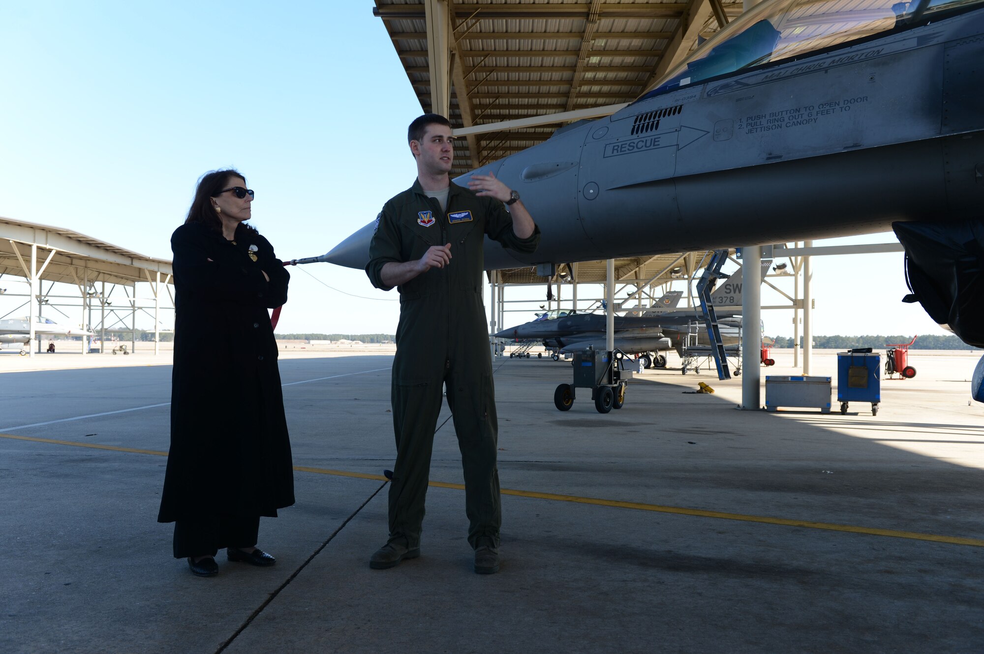Mary Anne Fitzpatrick, dean of the College of Arts and Sciences at the University of South Carolina, is briefed by U.S. Air Force Capt. Brandon Dobbs, F-16CM Fighting Falcon pilot, at Shaw Air Force Base, S.C., Feb. 11, 2015. Fitzpatrick learned about the capabilities of the fighter jet and received a tour of the base after speaking at the Ninth Air Force senior staff luncheon hosted by U.S. Air Force Maj. Gen. H.D. Polumbo Jr., Ninth Air Force commander. (U.S. Air Force photo by Senior Airman Jensen Stidham/Released) 