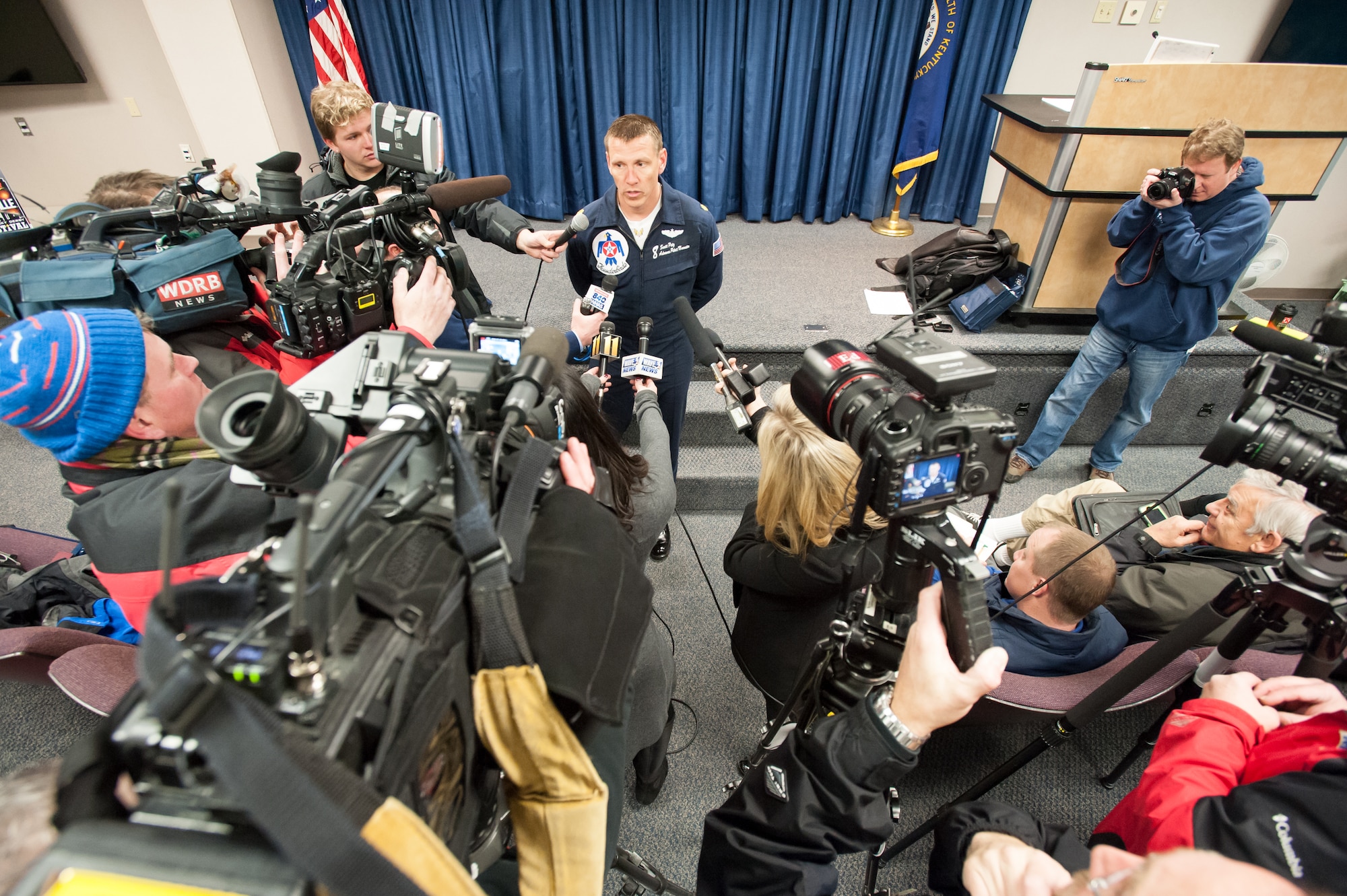 Maj. Scott Petz, a pilot with the U.S. Air Force Thunderbirds aerial demonstration squadron, speaks with members of the news media at the Kentucky Air National Guard Base in Louisville, Ky., Feb. 12, 2015. Petz was in Louisville to coordinate logistics for the Thunderbirds team, which will be the marquee attraction at this year’s Thunder Over Louisville air show April 18. (U.S. Air National Guard photo by Maj. Dale Greer)