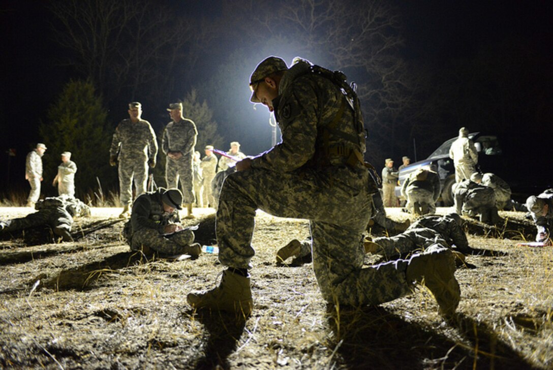 A soldier from the Army National Guard plots the points on his map using available light during the twilight land-navigation course at the 2015 Best Warrior Competition at Camp Swift, Texas, Feb. 7, 2015. The course started at 5a.m. and finished at daybreak. The competition determines the best of the best warrior amongst Army and Air National Guardsmen. (photo by Master Sgt. Charles Hatton/released)