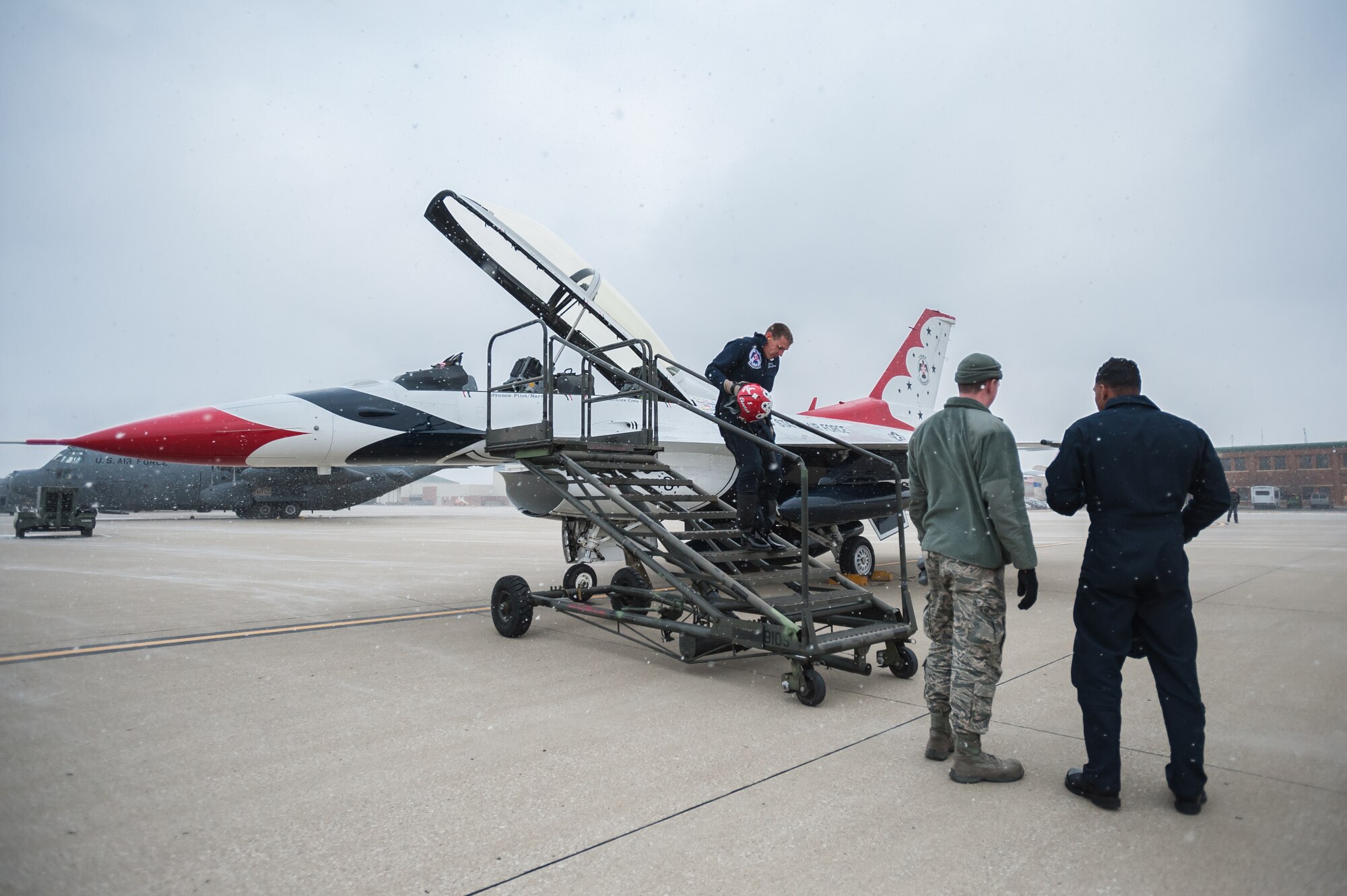Overcast skies and snow flurries greet Maj. Scott Petz, a pilot with the U.S. Air Force Thunderbirds aerial demonstration squadron, as he exits his F-16 Fighting Falcon at the Kentucky Air National Guard Base in Louisville, Ky., Feb. 12, 2015. Petz was in Louisville to coordinate logistics for the Thunderbirds team, which will be the marquee attraction at this year’s Thunder Over Louisville air show April 18. (U.S. Air National Guard photo by Maj. Dale Greer)