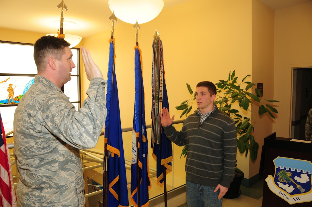 Airman 1st Class Luke Moyer raised his right hand and swore in to the 107th Airlift Wing New York Air National Guard here today.  He is the fifth in his family to carry on the military tradition. Feb. 12, 2015 (U.S. Air National Guard Photo/ Senior Master Sgt. Ray Lloyd)