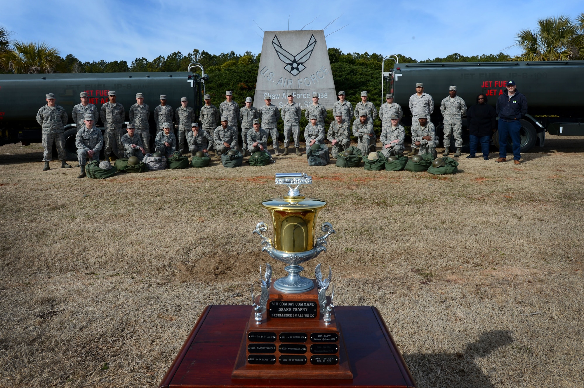 The 20th Logistic Readiness Squadron fuels management flight, stands behind the Drake Trophy at Shaw Air Force Base, S.C., Feb. 6, 2015. The Air Combat Command Drake Trophy is awarded annually to the most outstanding fuels management flight. (U.S. Air Force photo by Senior Airman Jensen Stidham/Released) 