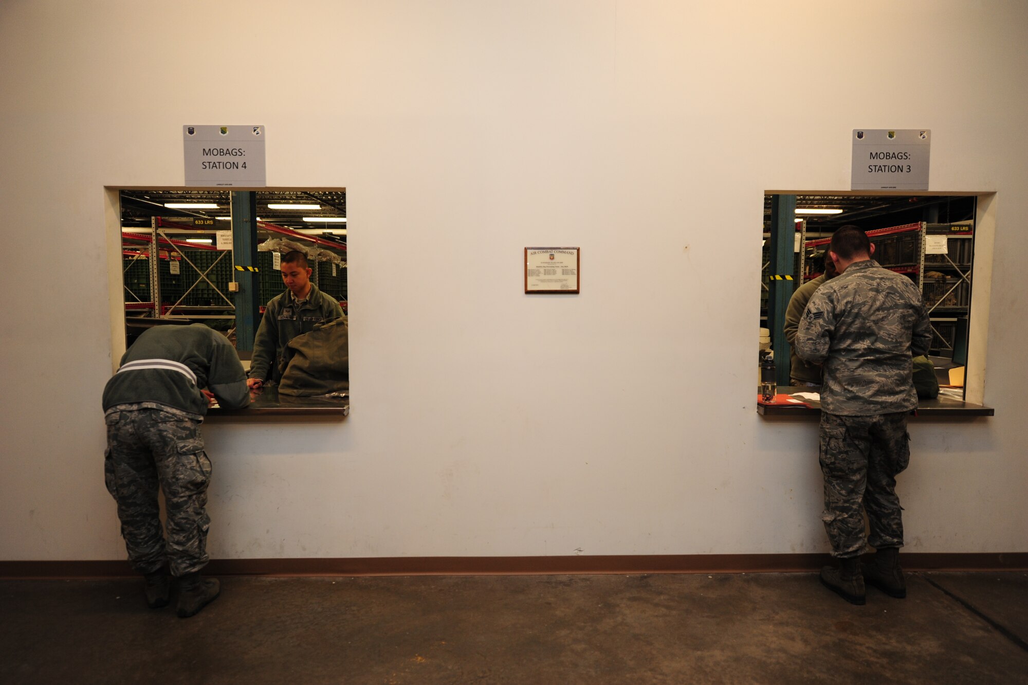 U.S. Air Force Airmen assigned to the 633rd Air Base Wing process through a predeployment line during a deployment exercise Feb. 10, 2015, at Langley Air Force Base, Va.  During the exercise, Airmen were designated to process through the line to test the line’s efficiency, and improve future processes for deploying at a moment’s notice. (U.S. Air Force photo by Staff Sgt. Natasha Stannard) 