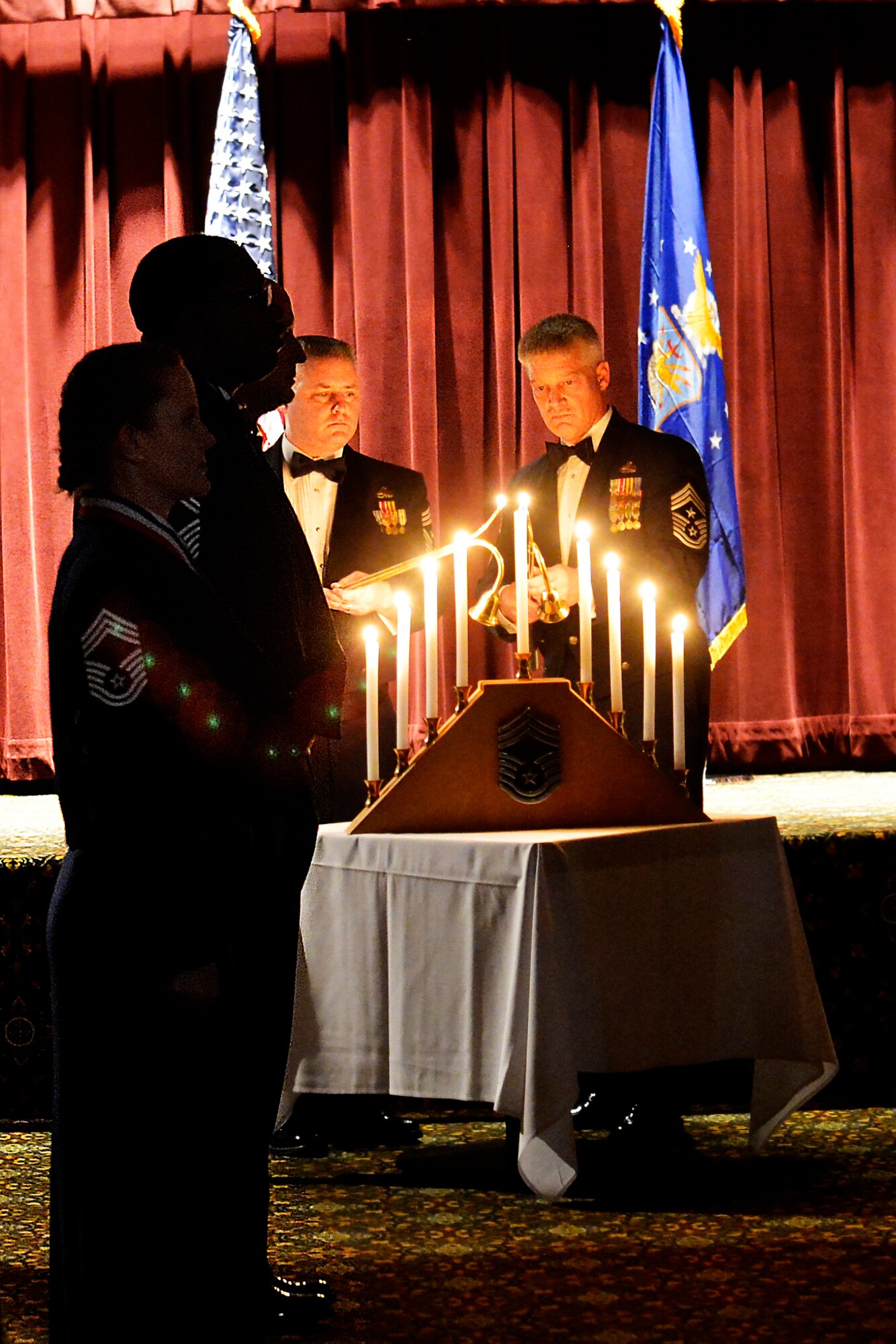 Chief Master Sgt. Tony Mack, 446th Airlift Wing command chief (left), and Chief Master Sgt. Gordon Drake, 62nd AW command chief, light the final candle on a candelabra symbolizing the nine enlisted ranks, Feb. 6, 2015, at Joint Base Lewis-McChord, Wash. Six Airmen were recognized during the Team McChord Chief Master Sergeant Induction Ceremony. (U.S. Air Force photo/Senior Airman Rebecca Blossom)