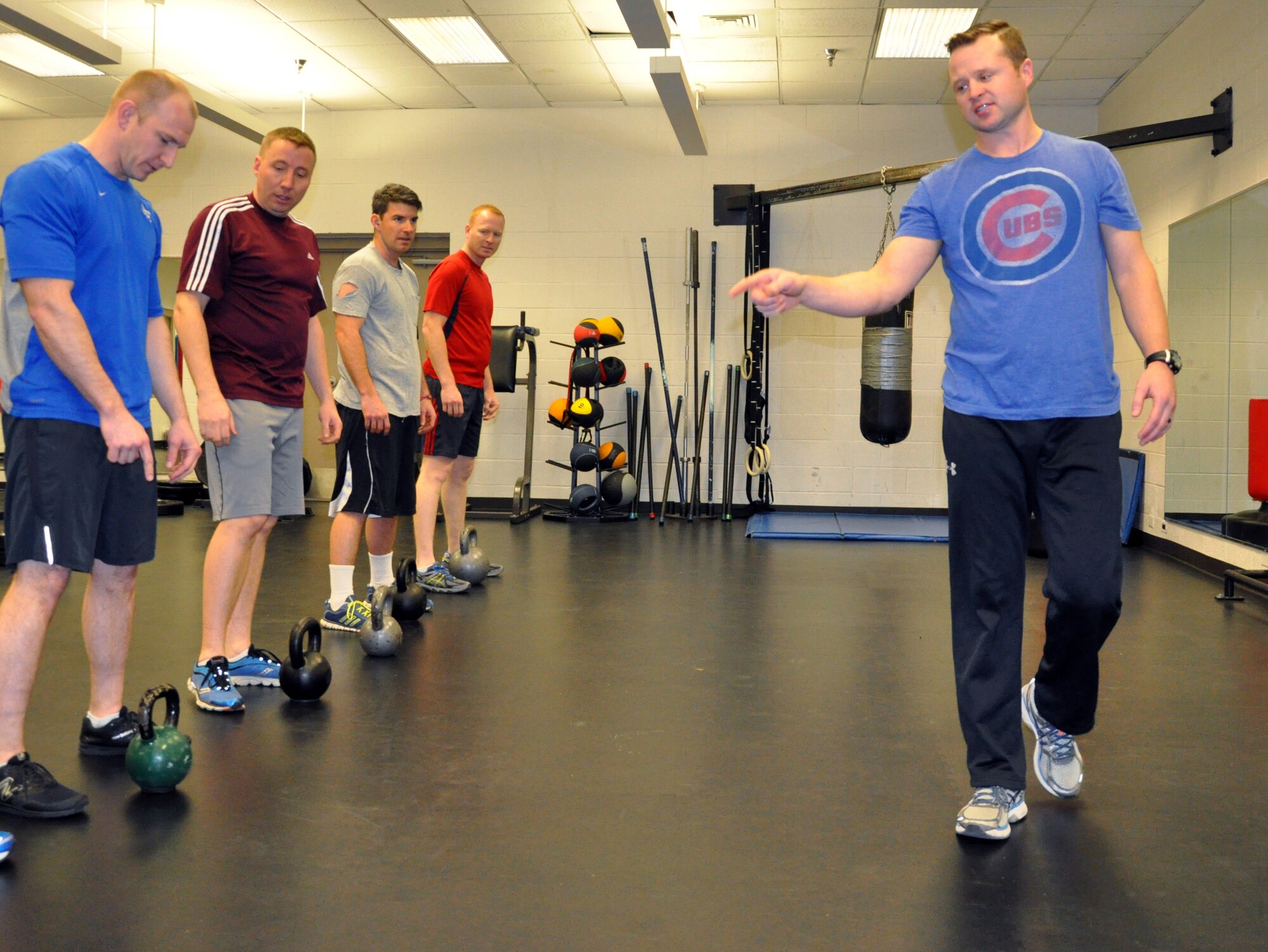 Tech. Sgt. Daniel Mills, a refueling boom operator assigned to the 18th Air Refueling Squadron, 931st Air Refueling Group, instructs unit members during a group workout at the base fitness center, Feb. 4, 2015. Mills leads daily workouts for unit members to improve overall fitness and help Airmen stay "fit to fight." (U.S. Air Force photo by Capt. Zach Anderson)
