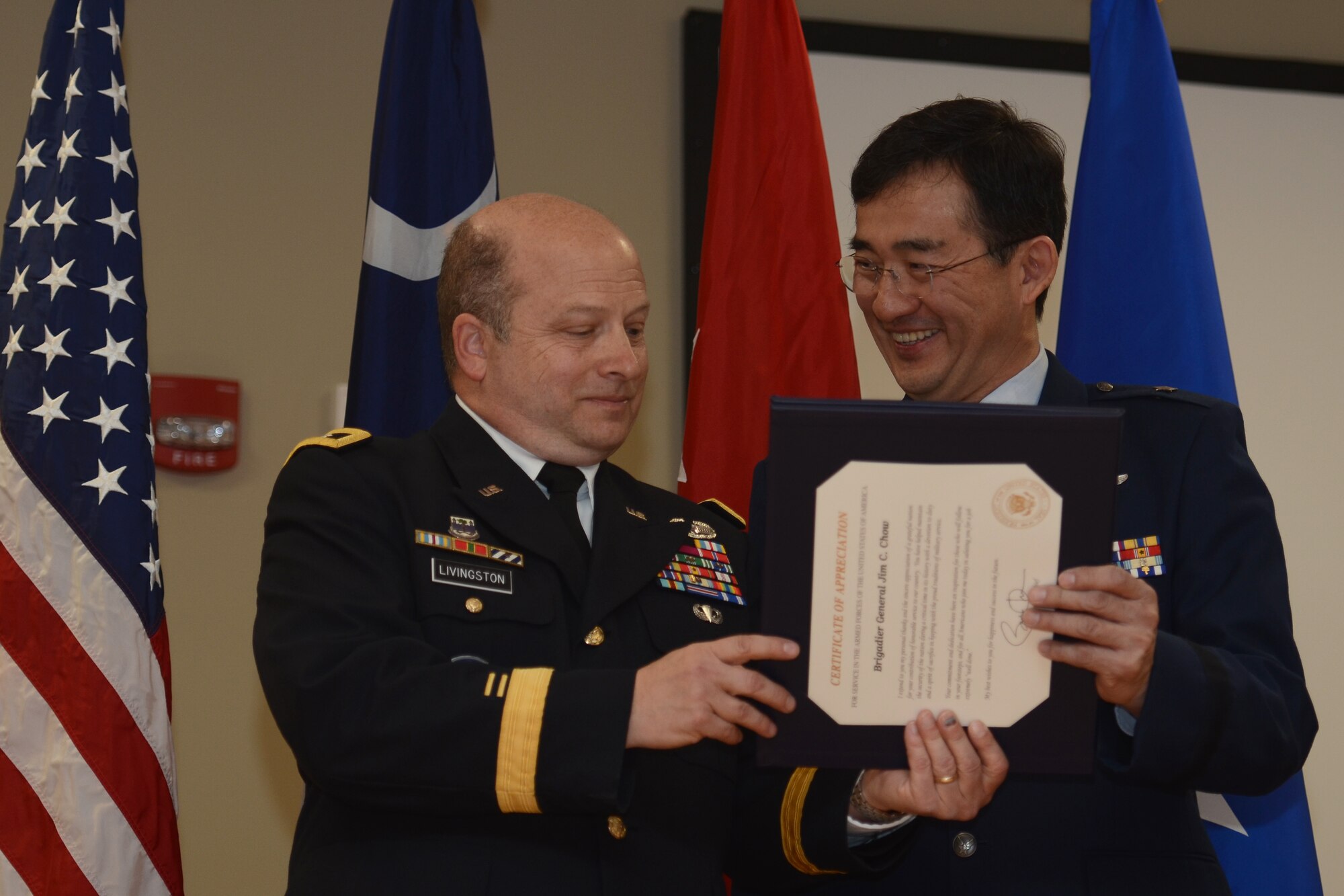 U.S. Army Maj. Gen. Robert E. Livingston Jr (left), the Adjutant General for South Carolina, presents a retirement certificate to U.S. Air Force Brig. Gen. (Dr.) Jim Chow, the State Air Surgeon and Assistant to the Director of the Air National Guard, at McEntire Joint National Guard Base, Feb. 8, 2015. Brig. Gen. Chow retired with thirty years of service to the South Carolina Air National Guard and the 169th Fighter Wing. (U.S. Air National Guard photo by Senior Master Sgt. Edward Snyder/Released)