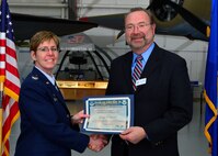 Col. Gretchen M. Wiltse, 512th Mission Support Group commander, presents a certificate of induction to George Krupanski, Boys & Girls Club of Delaware president and chief executive officer, as part of the Team Dover Honorary Commander Induction Ceremony Feb. 7, 2015, at the Air Mobility Command Museum. The Honorary Commander Program began in 1992 at Dover Air Force Base, Del.,to foster relationships between civic and military leaders. (U.S. Air Force photo/Airman 1st Class William Johnson)
