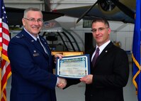 Col. Jonathan M. Philebaum, 512th Operations Group commander, presents a certificate of induction to Patrick Gallucci, First State Military Academy commandant, as part of the Team Dover Honorary Commander Induction Ceremony Feb. 7, 2015, at the Air Mobility Command Museum. The Honorary Commander Program began in 1992 at Dover Air Force Base, Del.,to foster relationships between civic and military leaders. (U.S. Air Force photo/Airman 1st Class William Johnson)