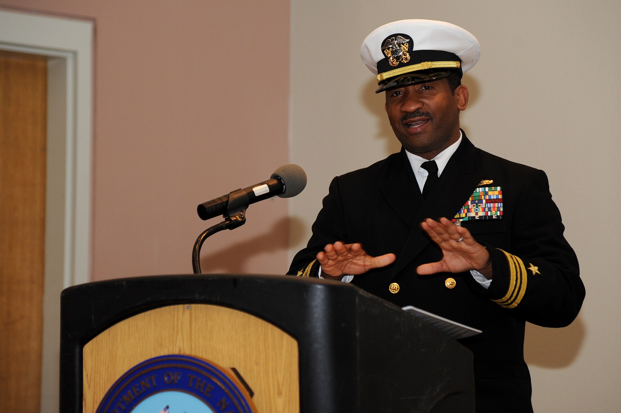 GOODFELLOW AIR FORCE BASE, Texas – U.S. Navy Lt. Cmdr. Cornell A. Woods, gives a speech before relinquishing command of the Navy Center for Information Dominance Detachment to Lt. Cmdr. Chris M. Allen during the change of charge ceremony at the Event Center Feb. 6. (U.S. Air Force photo/ Airman 1st Class Devin Boyer)