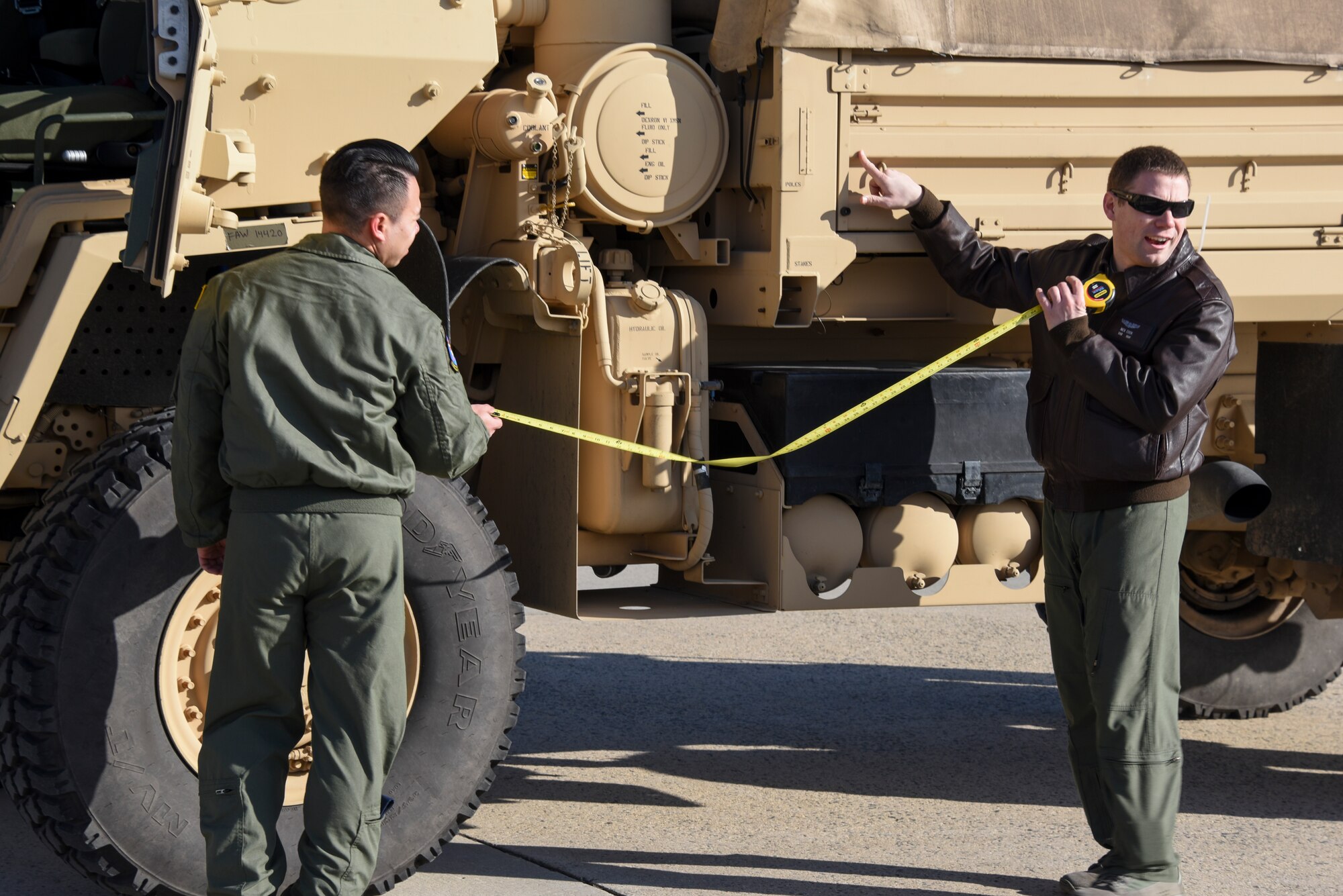Staff Sgt. Nick Cook, 6th Airlift Squadron load master, demonstrates how to measure cargo before it's loaded onto a C-17 Globemaster III during training at Joint Base McGuire-Dix-Lakehurst, N.J., Jan. 23, 2015. Load masters from the 305th Air Mobility Wing, the 514th Air Mobility Wing Reservists and the 621st Contingency Response Wing came together to receive hands-on training on the hazardous winch system. (U.S. Air Force photo by Airman 1st Class Tara A. Williamson/Released)