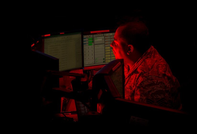 JOINT BASE CHARLESTON, S.C. – Tech. Sgt. Daniel Moore, 628th Air Base Wing Command Post controller, answer phones and tracks transient aircraft flight information in the Joint Base Charleston Command Post Feb. 11, 2015. A 24-hour operation, the CP coordinates both military and community aide.  When incidents happen on or off base, controllers are normally the first to know.  If off base organizations need assistance, the request goes through the CP. Additionally, CP reports those occurrences to higher headquarters.  (U.S. Air Force photo/ Senior Airman Dennis Sloan)