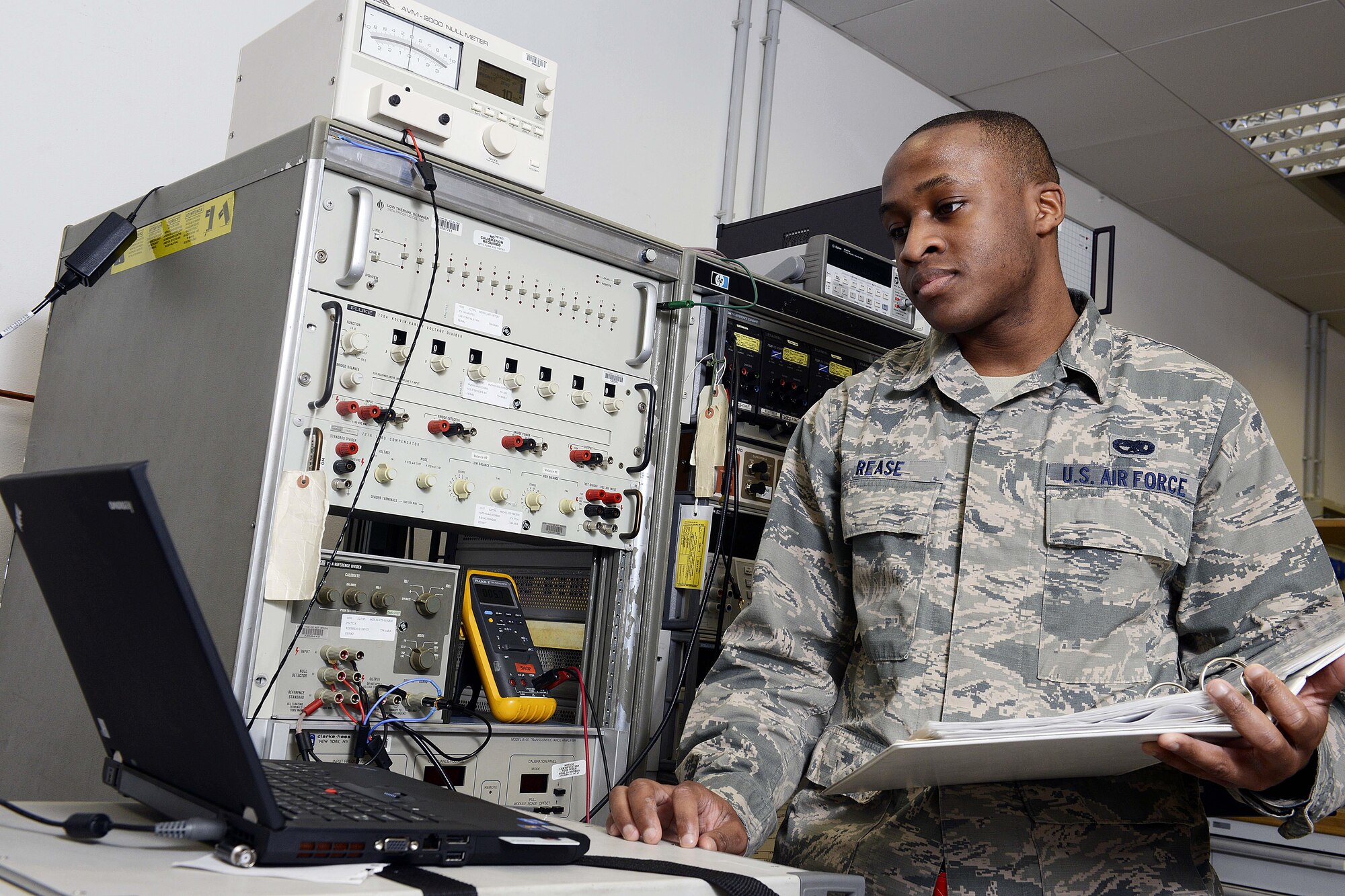 U.S. Air Force Senior Airman Julius Rease, 31st Maintenance Squadron precision measurement equipment laboratory journeyman, verifies DC voltage on a meter calibrator, Feb. 10, 2015, at Aviano Air Base, Italy. The PMEL Airmen support 5,200 different types of equipment on base for 84 different work centers. (U.S. Air Force photo by Airman 1st Class Ryan Conroy/Released) 