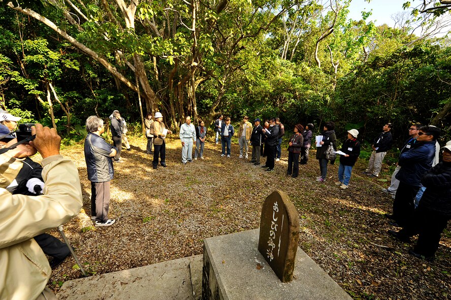 Members from the Chatan Hometown Association visit the Ashibi-na (playing square) on Kadena Air Base, Okinawa, Japan, Feb. 11, 2015. The tour was conducted to allow Chatan Hometown Association members to visit the places their ancestors used before World War II, such as gathering and worship sites, and water wells. (U.S. Air Force photo by Naoto Anazawa)