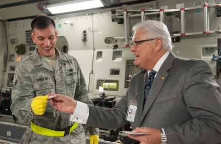 JOINT BASE CHARLESTON, S.C. – Dean Riegel, Joint Base Charleston Advisory Council member, thanks Airman 1st Class Eric Chmidling, 437th Aerial Port Squadron fleet services agent, and shares his business card after a briefing for community leaders at the Air Base Feb. 11, 2015. The briefing came as part of a week-long tribute to Charleston’s Nighttime Warriors—the men and women who keep the mission going after dark. (U.S. Air Force Photo/Capt. Christopher Love)