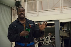 JOINT BASE CHARLESTON, S.C. – Paul Mansfield, 437th Maintenance Squadron Aerospace Ground Equipment technician, briefs community leaders about his role in maintaining an ESSEX Generator at Joint Base Charleston, S.C., Feb. 11, 2015. The tour exposed the leaders to the important contributions of Charleston’s Nighttime Warriors. Mansfield, a former service member, has filled a civilian position at Joint Base Charleston since 1986 and has worked night shift since 2007. (U.S. Air Force Photo/Capt. Christopher Love)
