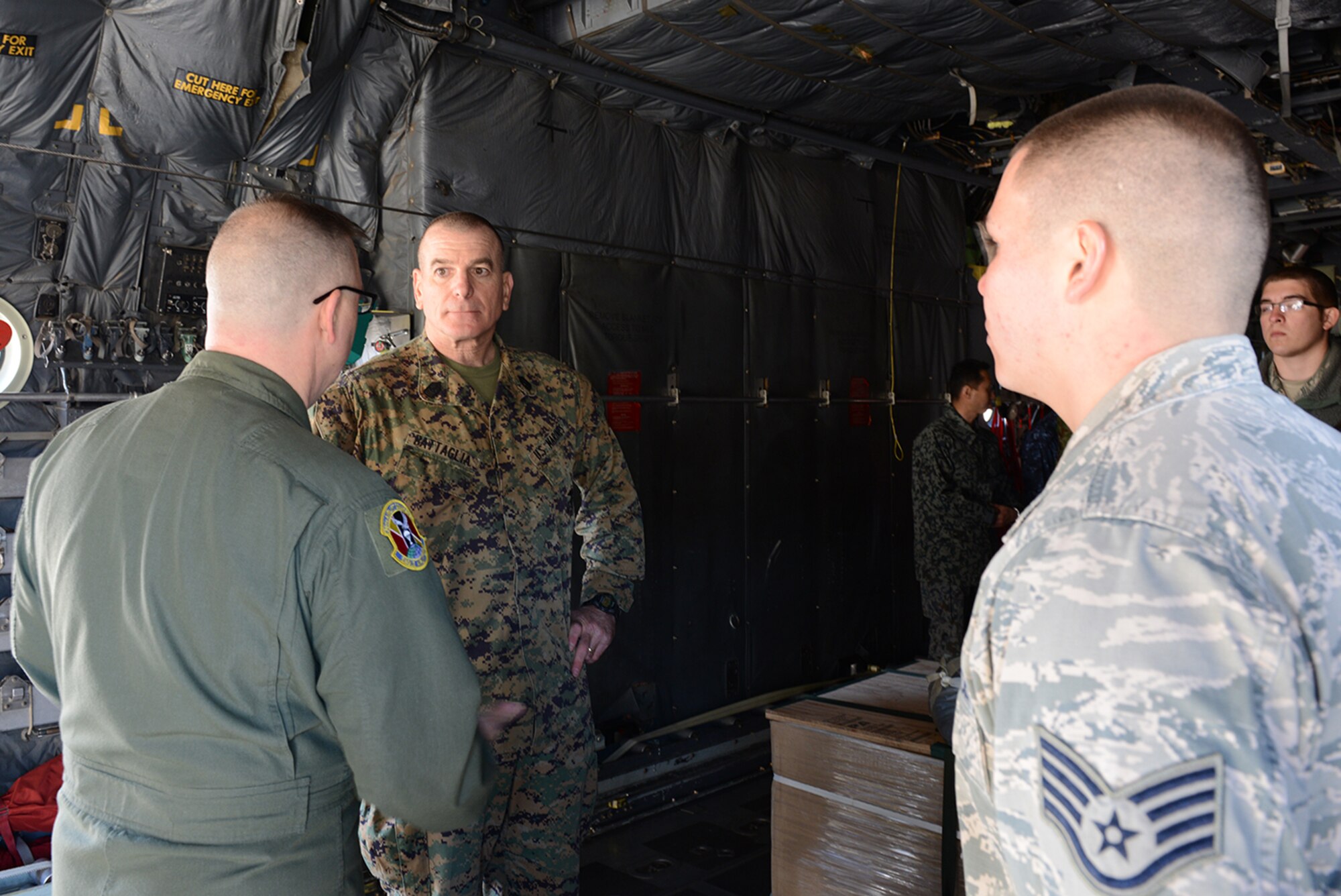 Chief Master Sgt. Reynold Albright, 36th Airlift Squadron chief enlisted manager, explains low-cost, low-altitude pallets to Marine Corps Sgt. Maj. Bryan Battaglia, senior enlisted advisor to the chairman of the Joint Chiefs of Staff, at Yokota Air Base, Japan, Feb. 11, 2015. Pallets are modified according to mission requirements and Albright highlighted special variations made for dropping into water for Operation Christmas Drop, a humanitarian airdrop mission in the Pacific. (U.S. Air Force photo by Senior Airman Desiree Economides/Released)