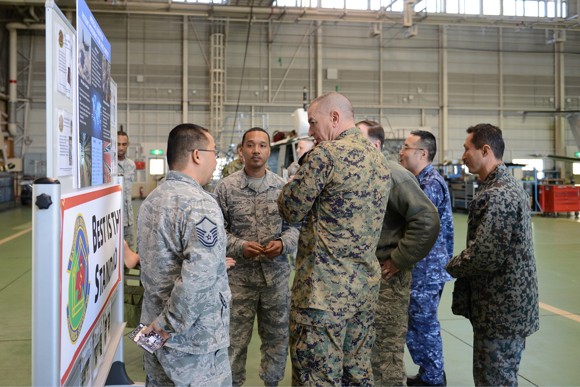Master Sgt. Charles Sellers, 374th Medical Surgical Squadron, talks to Marine Corps Sgt. Maj. Bryan Battaglia, the senior enlisted advisor to the chairman of the Joint Chiefs of Staff, about patient transportation, Feb. 11, 2015, at Yokota Air Base, Japan. Battaglia is joined in the briefings by Japan Self-Defense Force members, whom he also met with while visiting Yokota. (U.S. Air Force photo by Senior Airman Desiree Economides/Released)