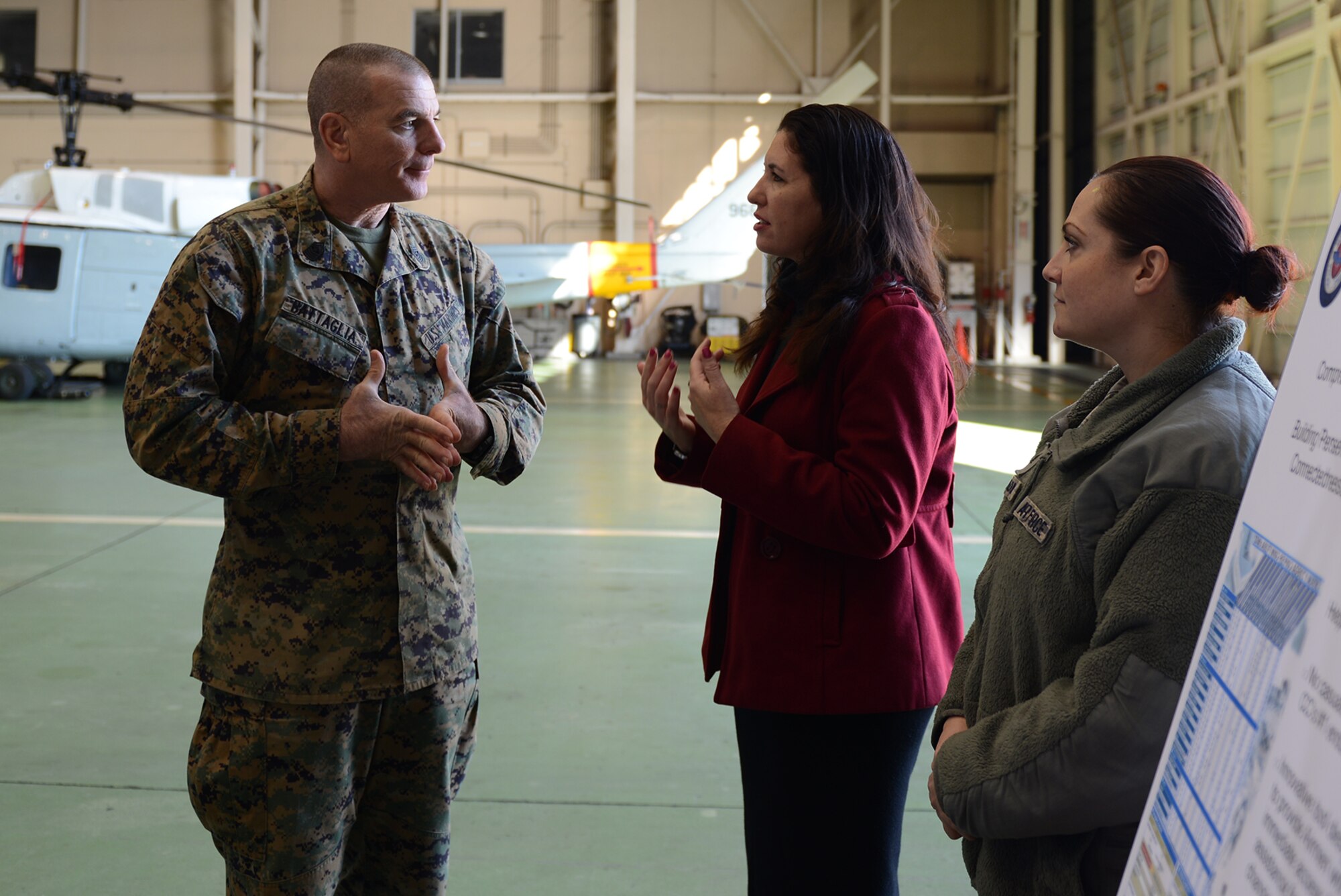 Micaela Alexander, 374th Airlift Wing community support coordinator, speaks with Marine Corps Sgt. Maj. Bryan Battaglia, the senior enlisted advisor to the chairman of the Joint Chiefs of Staff, about the Resiliency program at Yokota Air Base, Japan, Feb. 11, 2015. Battaglia stopped at Yokota while he visited military installations throughout Korea and Japan. (U.S. Air Force photo by Senior Airman Desiree Economides/Released)