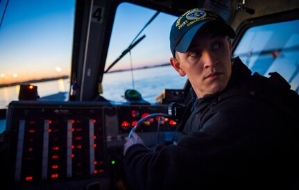 Master at Arms 2nd Class Michael Harkey, 628th Security Force Squadron level two coxswain, listens for orders Feb. 11, 2015, at Dock Charlie on Joint Base Charleston – Weapons Station, S.C. The night operation demonstrated the Defenders’ insertion and extraction capabilities, while increasing teamwork and camaraderie.  (U.S. Air Force photo/Airman 1st Class Clayton Cupit)