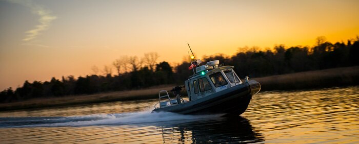 A 628th Security Forces Squadron patrol boat speeds through the water Feb. 11, 2015, at Dock Charlie on Joint Base Charleston – Weapons Station, S.C. Night or day, rain or shine, the Defenders patrol the miles of shoreline at the Weapons Station. (U.S. Air Force photo/Airman 1st Class Clayton Cupit)
