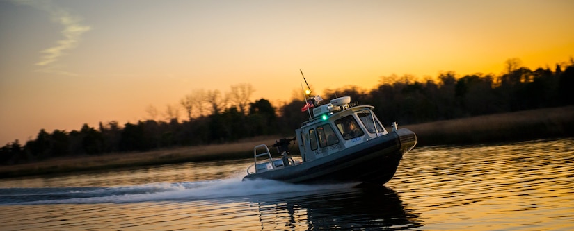 A 628th Security Forces Squadron patrol boat speeds through the water Feb. 11, 2015, at Dock Charlie on Joint Base Charleston – Weapons Station, S.C. Night or day, rain or shine, the Defenders patrol the miles of shoreline at the Weapons Station. (U.S. Air Force photo/Airman 1st Class Clayton Cupit)