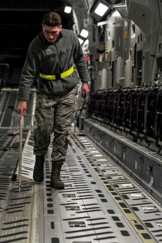 Senior Airman Anthony Landry, a crew chief with the 437th Aircraft Maintenance Squadron, inspects the aerial delivery system on a C-17 Globemaster III at Joint Base Charleston, S.C., Feb. 11, 2015. Landry checked pressure in the rail system and the lock arm release functions to ensure the plane was prepared for its drop mission the next day. (U.S. Air Force photo/Tech. Sgt. Renae Pittman)