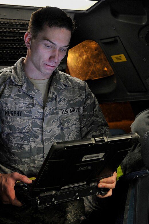 Airman Patrick Murphy, an integrated communications countermeasure navigation system technician with the 437th Aircraft Maintenance Squadron, troubleshoots a radio fault reported during a post-flight briefing with crew members at Joint Base Charleston, S.C., Feb, 11, 2015. Murphy analyzes malfunctions as well as inspects, removes, maintains, and installs integrated avionics systems on the C-17 Globemaster III—all while working the mid shift. (U.S. Air Force photo/Tech. Sgt. Renae Pittman)