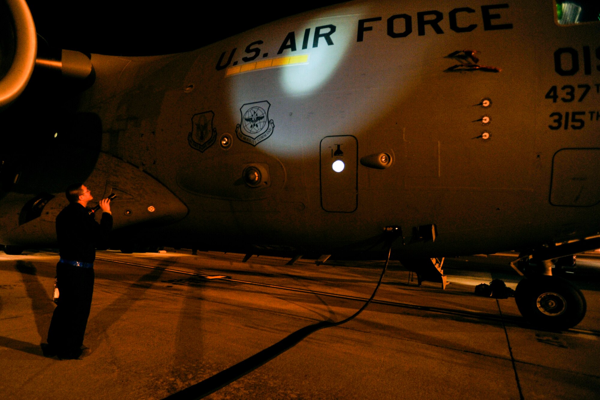 Staff Sgt. Jack Dennis, a crew chief with 437th Aircraft Maintenance Squadron, inspects the right side exterior of a C-17 Globemaster III during a thru flight inspection at Joint Base Charleston, S.C., Feb. 10, 2015. The C-17 undergoes multiple inspections both before and after every mission, no matter what time of day. (U.S. Air Force photo/Tech. Sgt. Renae Pittman)