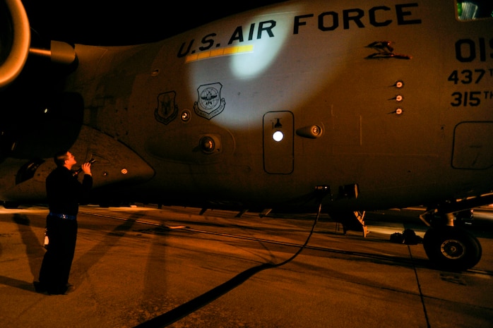 Staff Sgt. Jack Dennis, a crew chief with 437th Aircraft Maintenance Squadron, inspects the right side exterior of a C-17 Globemaster III during a thru flight inspection at Joint Base Charleston, S.C., Feb. 10, 2015. The C-17 undergoes multiple inspections both before and after every mission, no matter what time of day. (U.S. Air Force photo/Tech. Sgt. Renae Pittman)