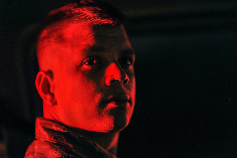 Senior Airman Dylan Churby, a vehicle operator with the 628th Logistics Readiness Squadron, watches training on the flight line while awaiting clearance to pass at Joint Base Charleston, S.C., Feb. 10, 2015. Although assigned to swing shift, Churby often stays late in order to ensure mission success. (U.S. Air Force photo/Tech. Sgt. Renae Pittman)