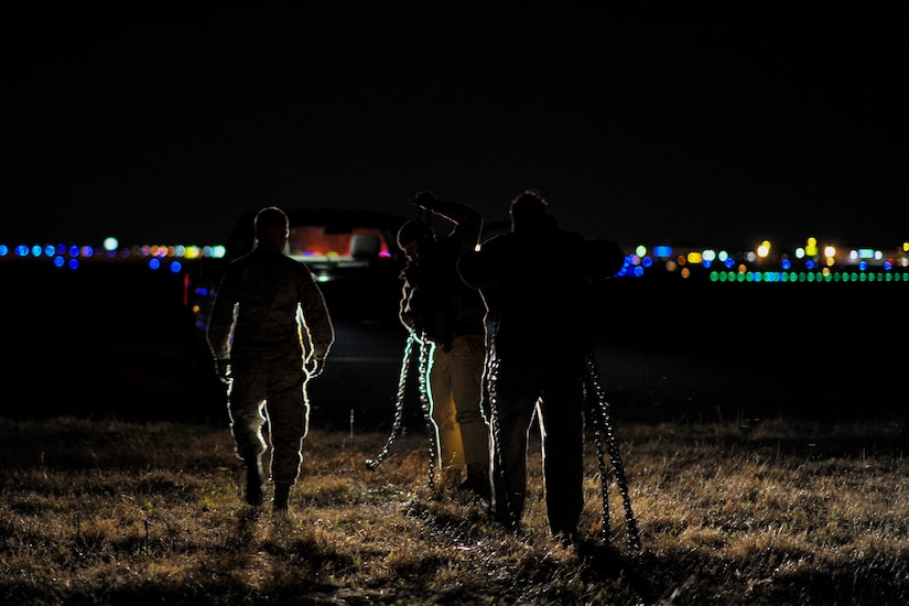 Senior Airman Dylan Churby (left), a vehicle operator with the 628th Logistics Readiness Squadron, helps members from another unit get their vehicle unstuck from the mud Feb. 10, 2015 at Joint Base Charleston, S.C. The vehicle operations section is manned 24 hours a day, seven days a week in order to provide transportation assistance to members of the base. (U.S. Air Force photo/Tech. Sgt. Renae Pittman)