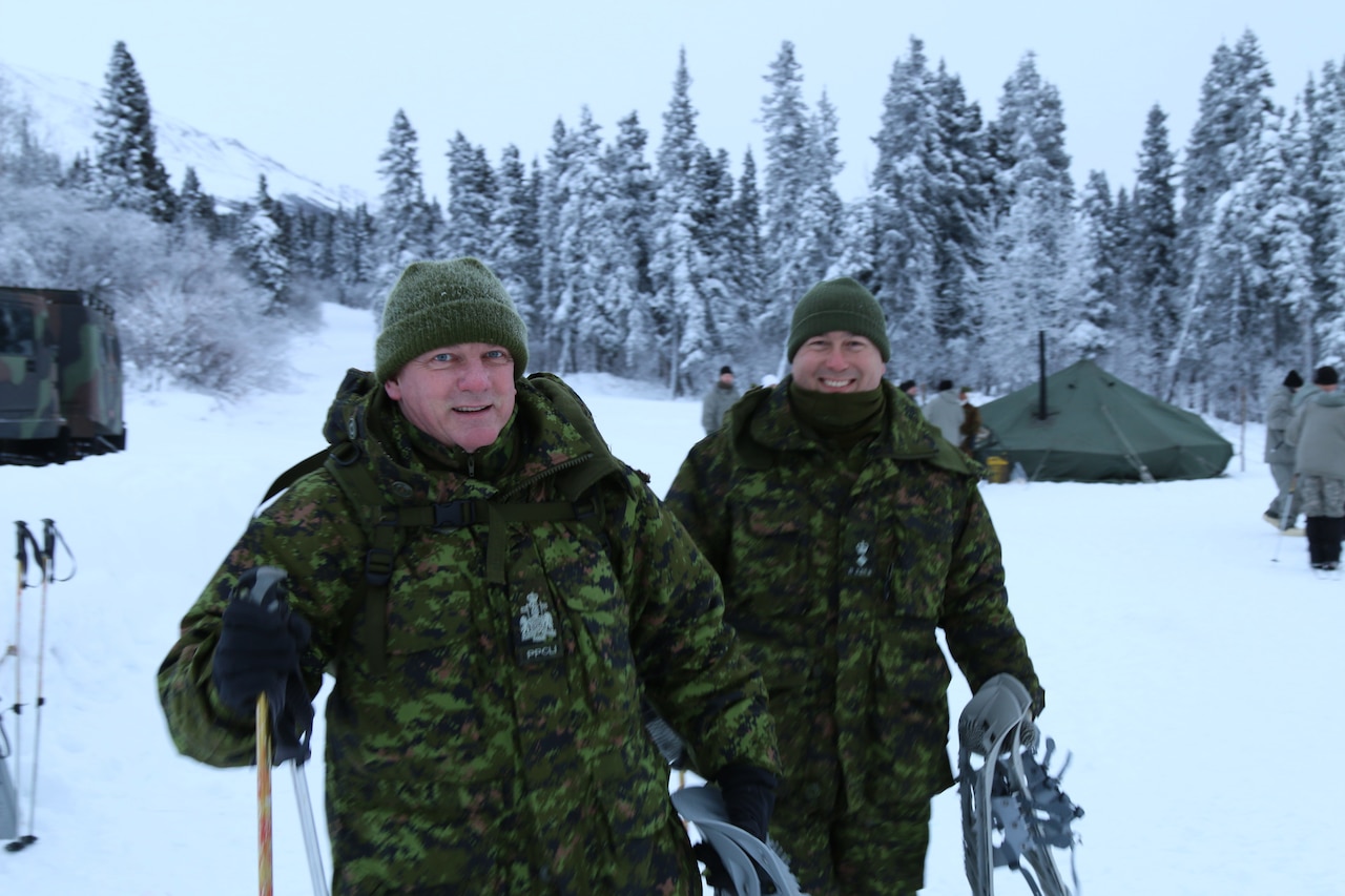 Chief Warrant Officer Steve Merrym, left, and Lt. Col. Francois Dufault, both from the Canadian army, gear up during the Cold Regions Military Mountaineering Collaborative Event at the Northern Warfare Training Center in Black Rapids, Alaska, Feb. 11, 2015. U.S. Army photo by Sgt. Sean Callahan