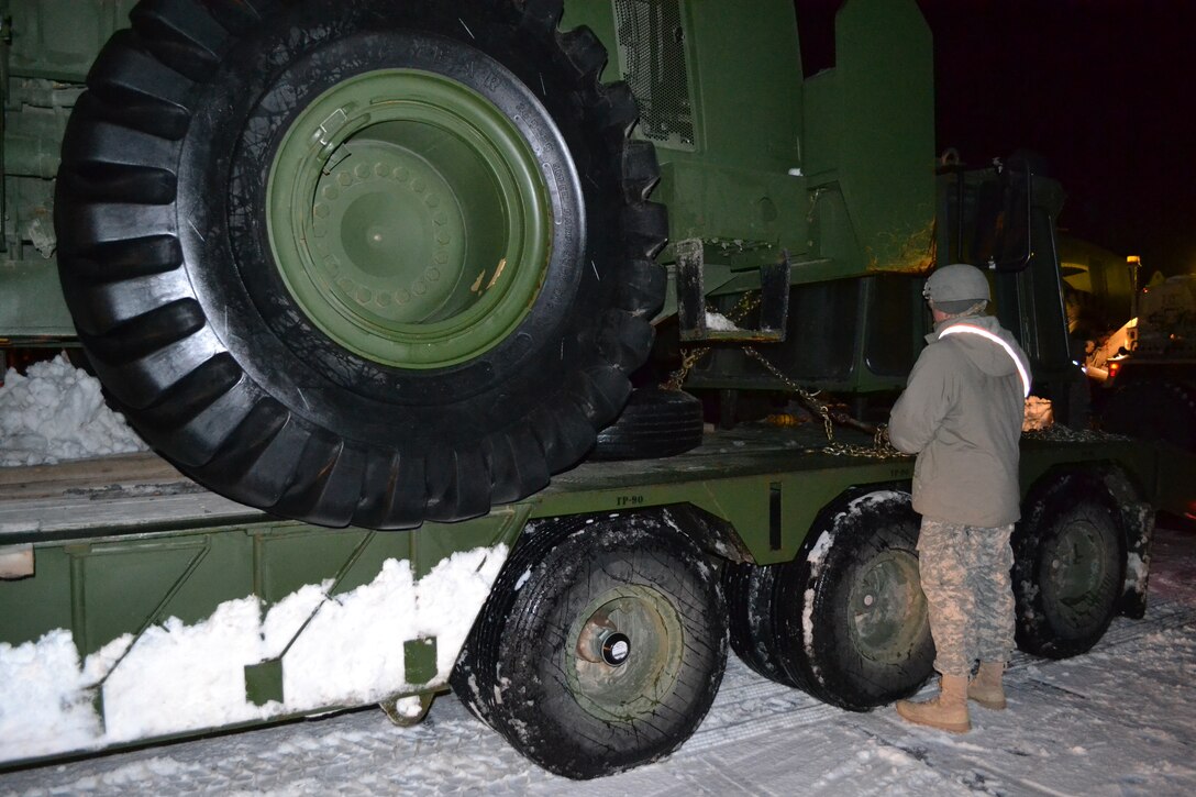 Massachusetts Army National Guard soldiers arrive on a late winter night to stage their unit’s heavy equipment in Weymouth, Mass., Feb. 11, 2015. The soldiers are assisting South Shore communities with snow removal from the recent devastating snow fall hitting the state. 