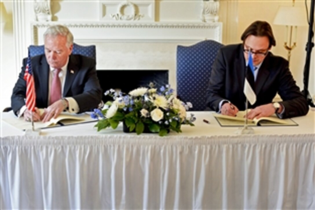 Acting Assistant Defense Secretary for Reserve Affairs Richard O. Wightman Jr., left, and Estonian Ambassador Eerik Marmei sign an official agreement at the Estonian Embassy in Washington, D.C., Feb. 10, 2015, expanding opportunities for Guardsmen and reservists to exchange forces to improve NATO interoperability. The Military Reserve Exchange Program calls for exchanges in cyber, maneuver and special warfare. 