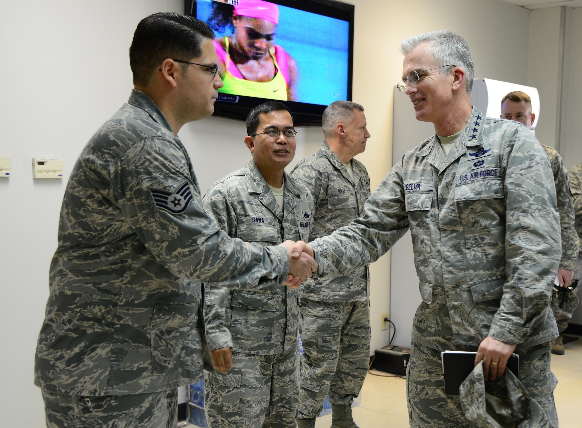 U.S. Air Force Gen. Paul Selva, right, commander of U.S. Transportation Command, shakes hands with Staff Sgt. Steven Wilson, 8th Expeditionary Air Mobility Squadron, during his visit Jan. 31, 2015, at Al Udeid Air Base, Qatar. The 8th EAMS, also known as “the Ochos”, support approximately 9,000 transient servicemembers each month. USTRANSCOM is the single manager of global air, land and sea transportation for the Department of Defense. (U.S. Air Force photo by Senior Airman Kia Atkins)