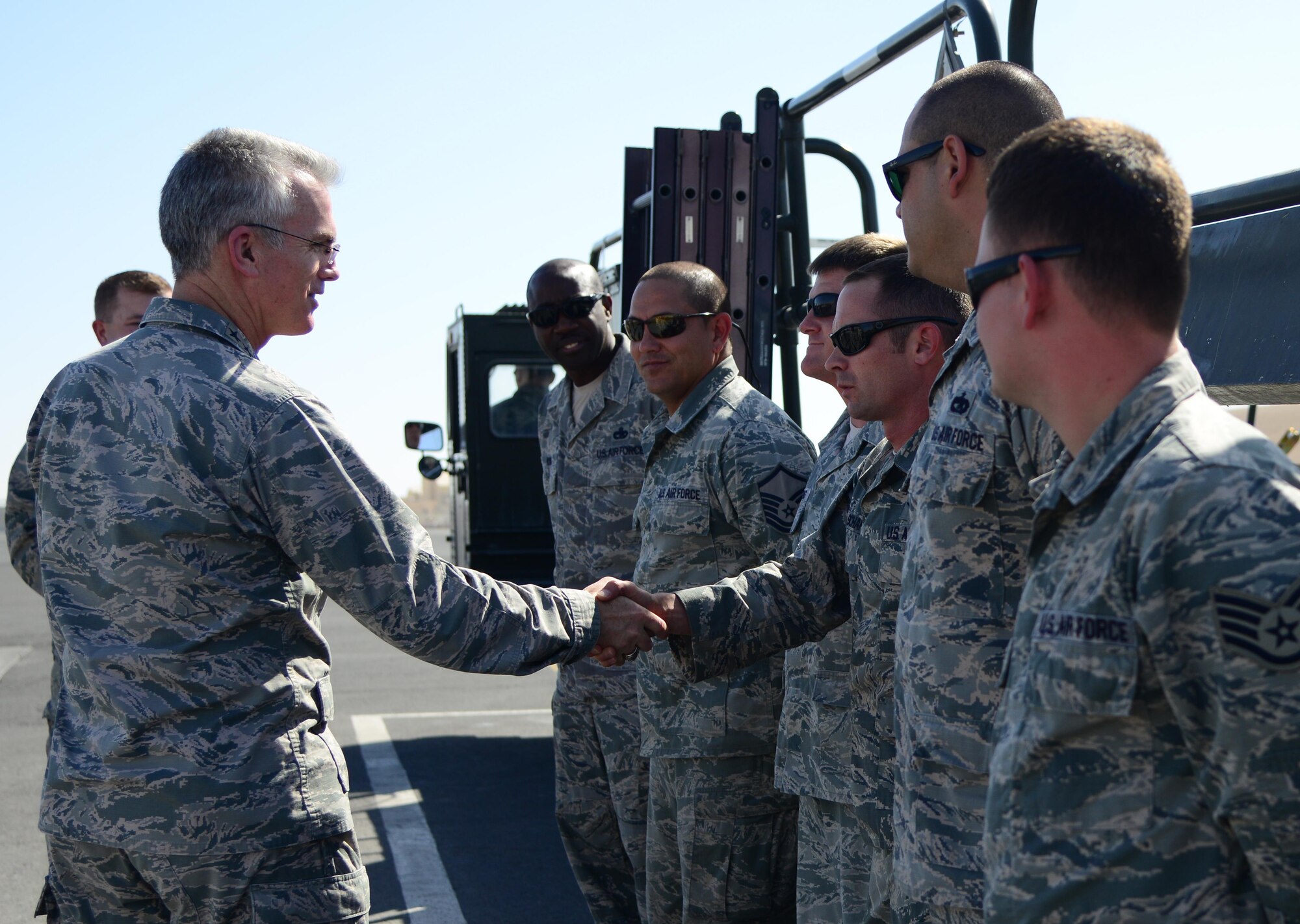 U.S. Air Force Gen. Paul Selva, left, commander of U.S. Transportation Command, shakes hands with Airmen from the 8th Expeditionary Air Mobility Squadron during his visit, Jan. 31, 2015, at Al Udeid Air Base, Qatar. Selva visited several squadrons on base where he met with Airmen and thanked them for what they contribute to the mission. USTRANSCOM is the single manager of global air, land and sea transportation for the Department of Defense. (U.S. Air Force photo by Senior Airman Kia Atkins)